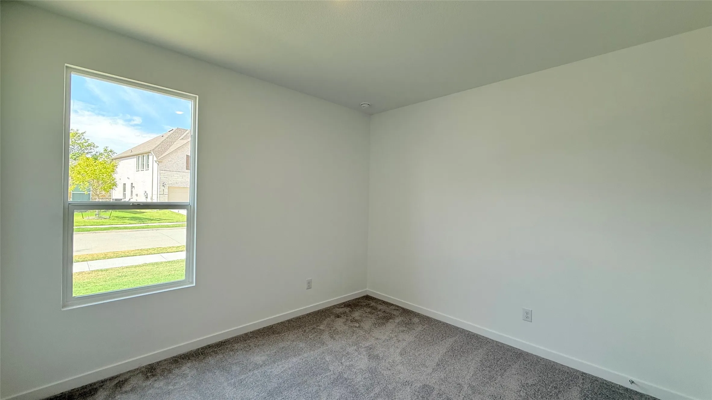 Neutral wall finishes, recessed ceiling lighting, and gray carpet flooring