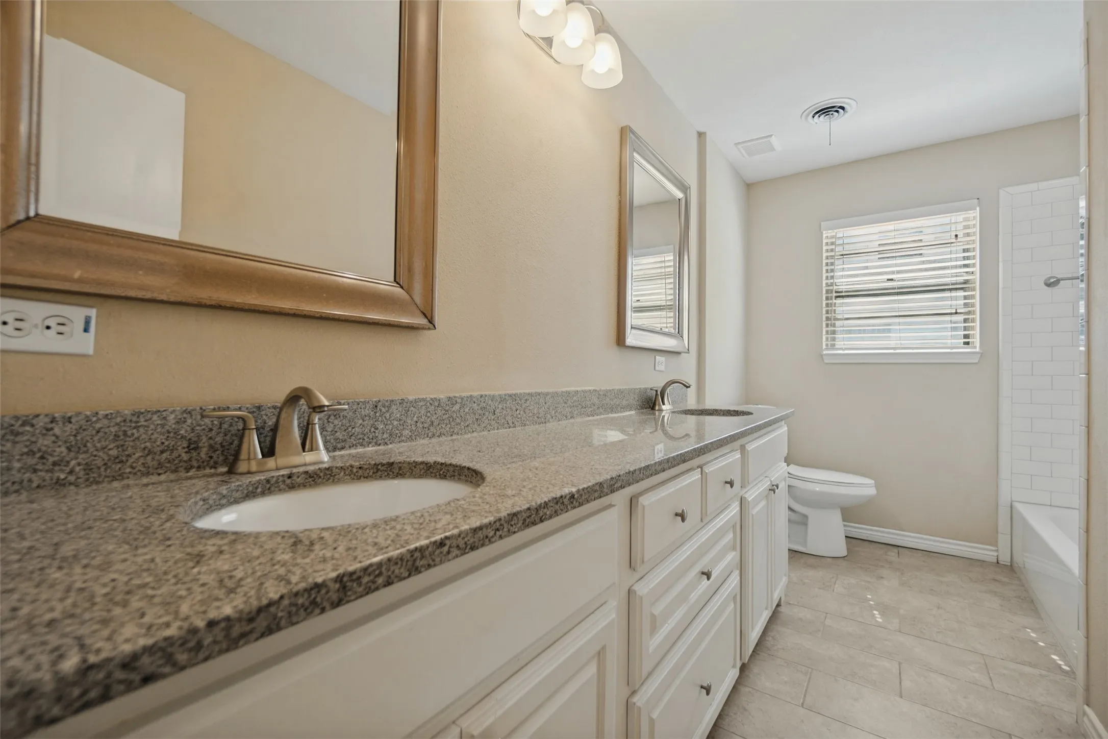 Hall bath with tub/shower, granite counters and updated tile.