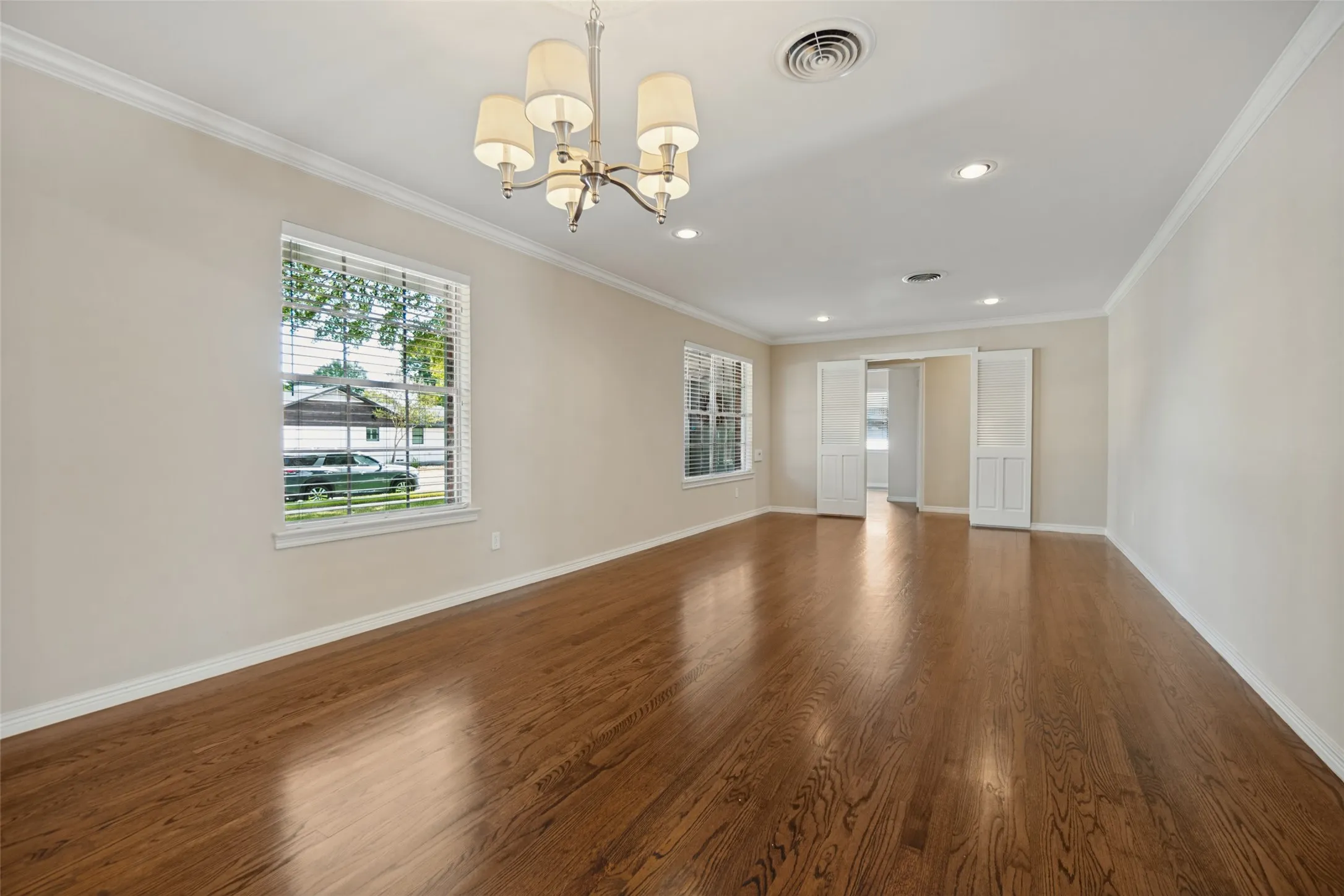 Spacious living/dining room. Beautifully refinished hardwood flooring throughout.