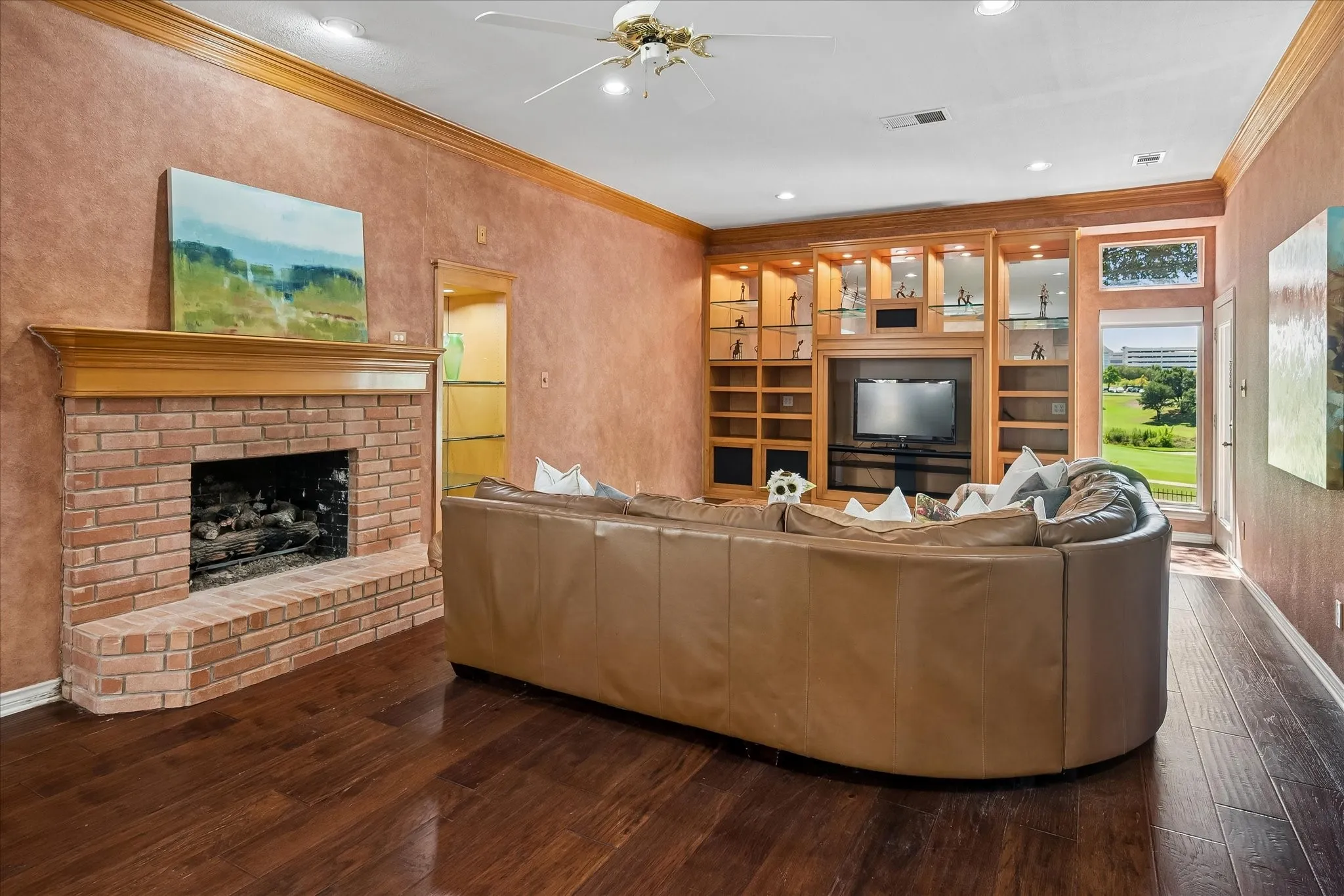 The room has a cozy feel but is large enough for two seating areas, one by the fireplace and the other for TV or golf viewing