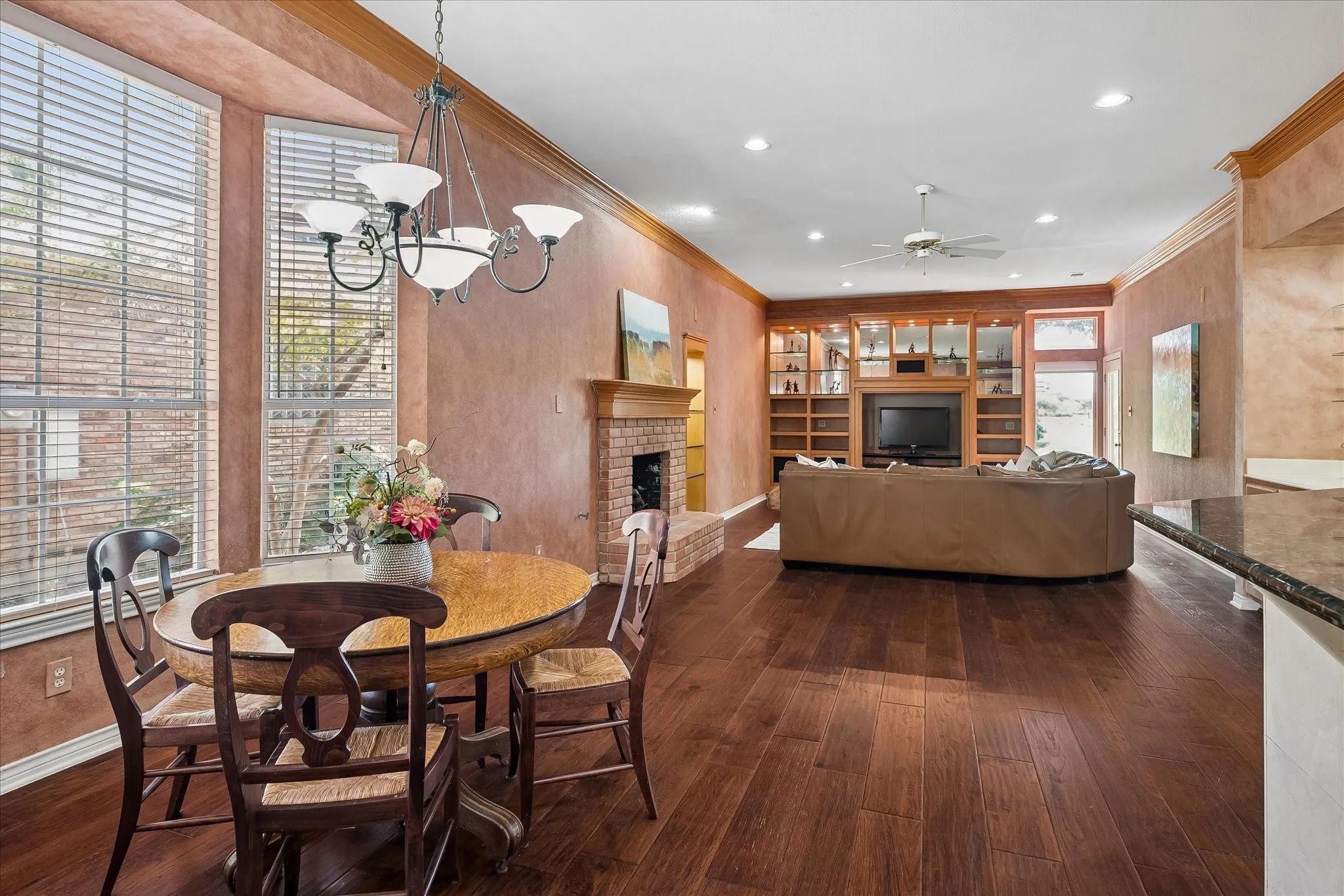 Beautiful  American Hickory hardwood throughout, featuring a brick-surround fireplace, custom built-in entertainment center, and plenty of room for a large breakfast table!