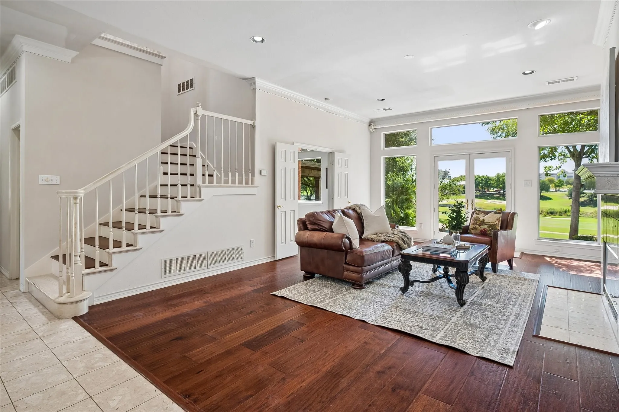 Expansive living area with rich and durable American Hickory hardwood, a grand staircase with wood steps, white balusters, and dental molding are the backdrop for the star of this home, the incredible views!!
