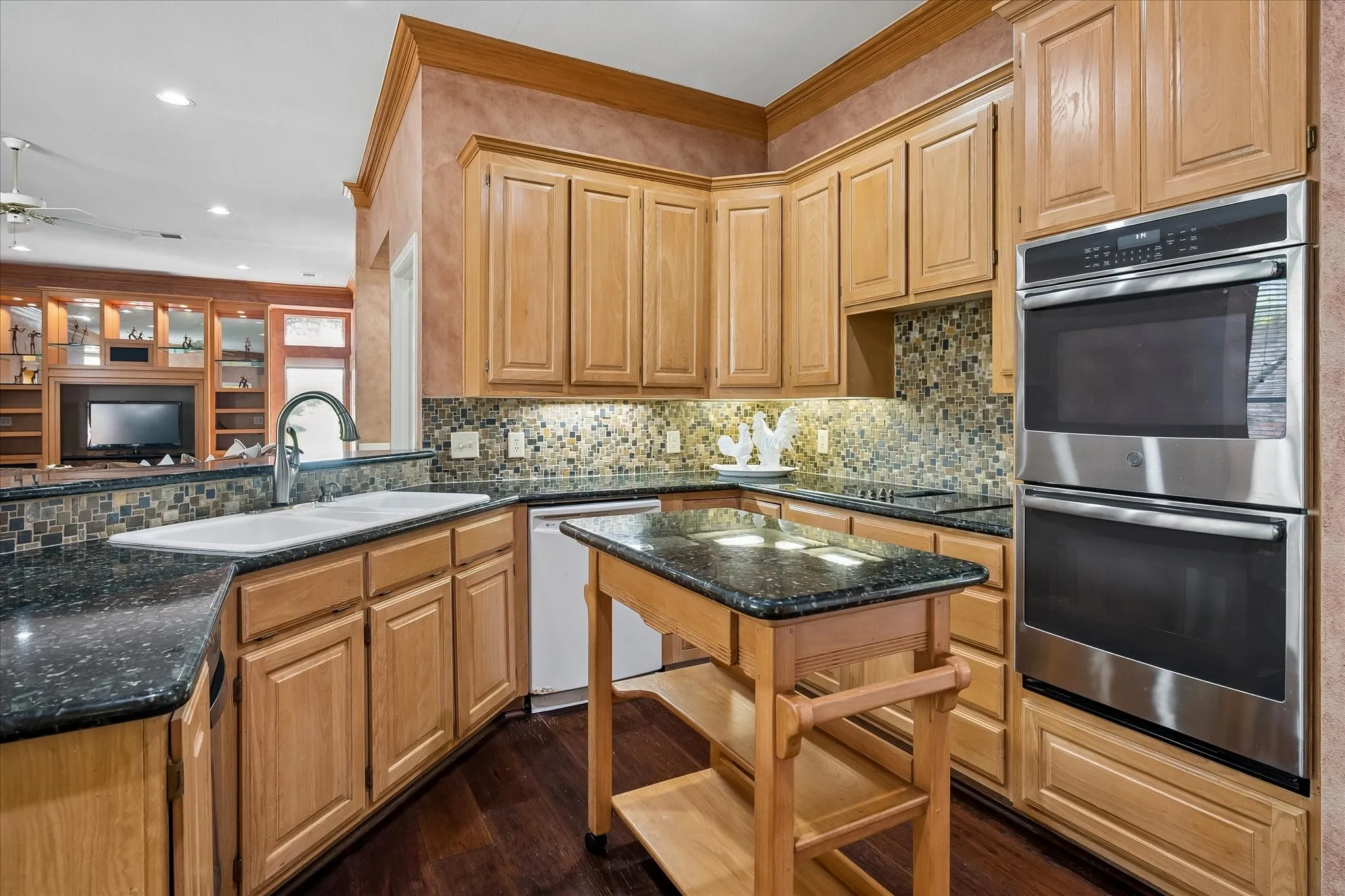 `Decorative tile backsplash sets off this chefs kitchen with stainless double ovens, top is convection and bottom conventional.  Also featuring induction cooktop with down draft and 3 compartment kitchen sink