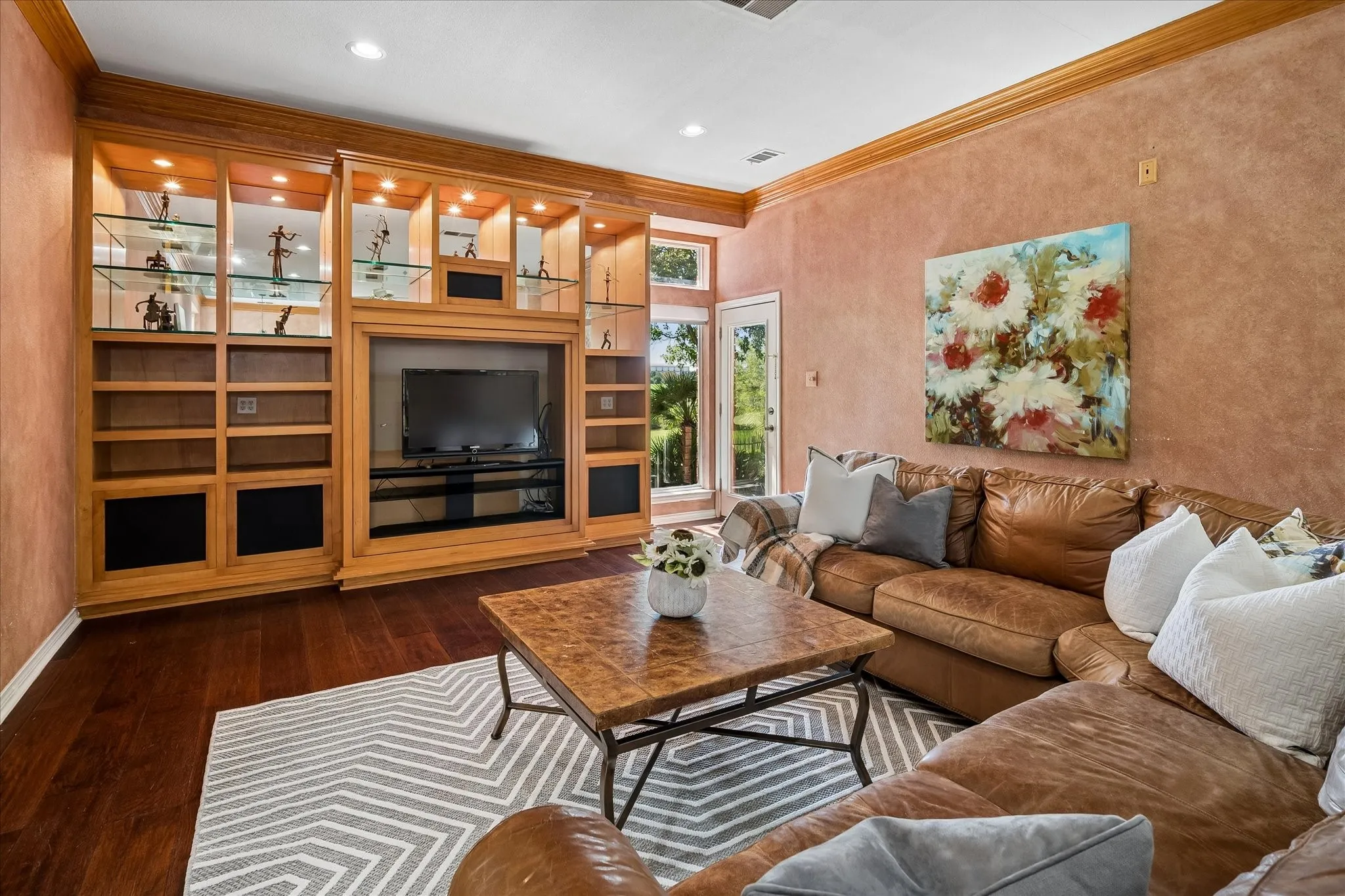 Built-in entertainment center with display shelving and integrated lighting.