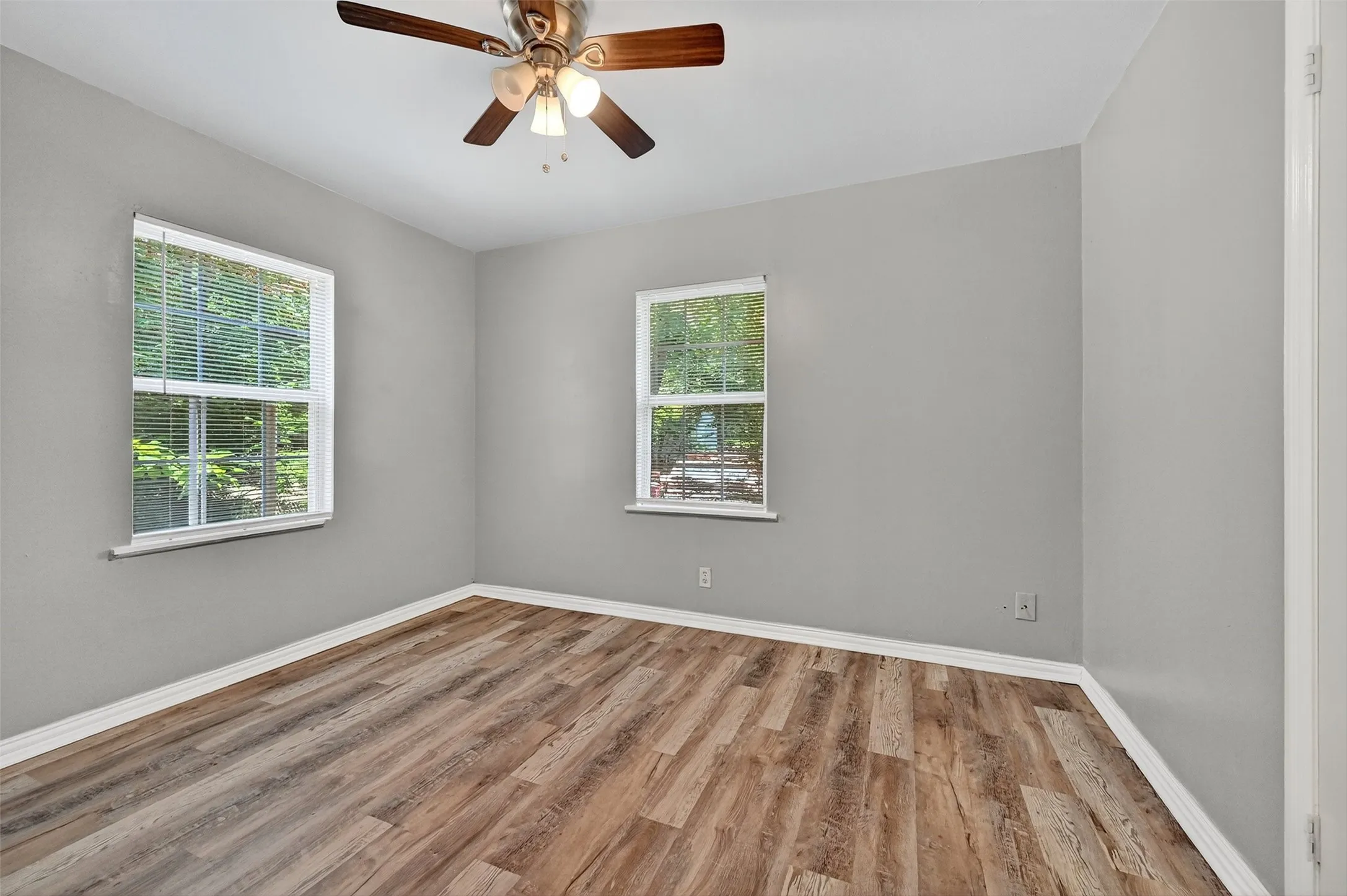 Spare room featuring wood finished floors and a ceiling fan
