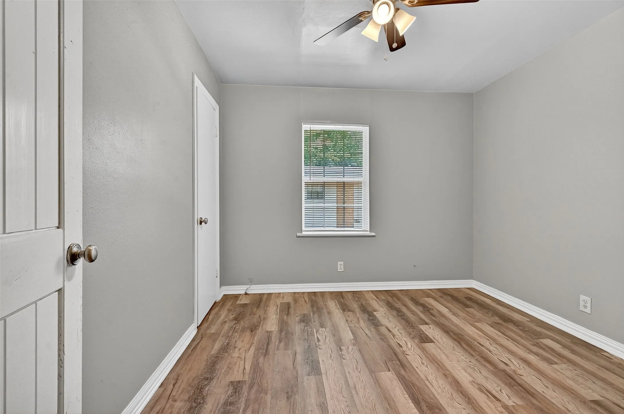 Empty room featuring ceiling fan and wood finished floors