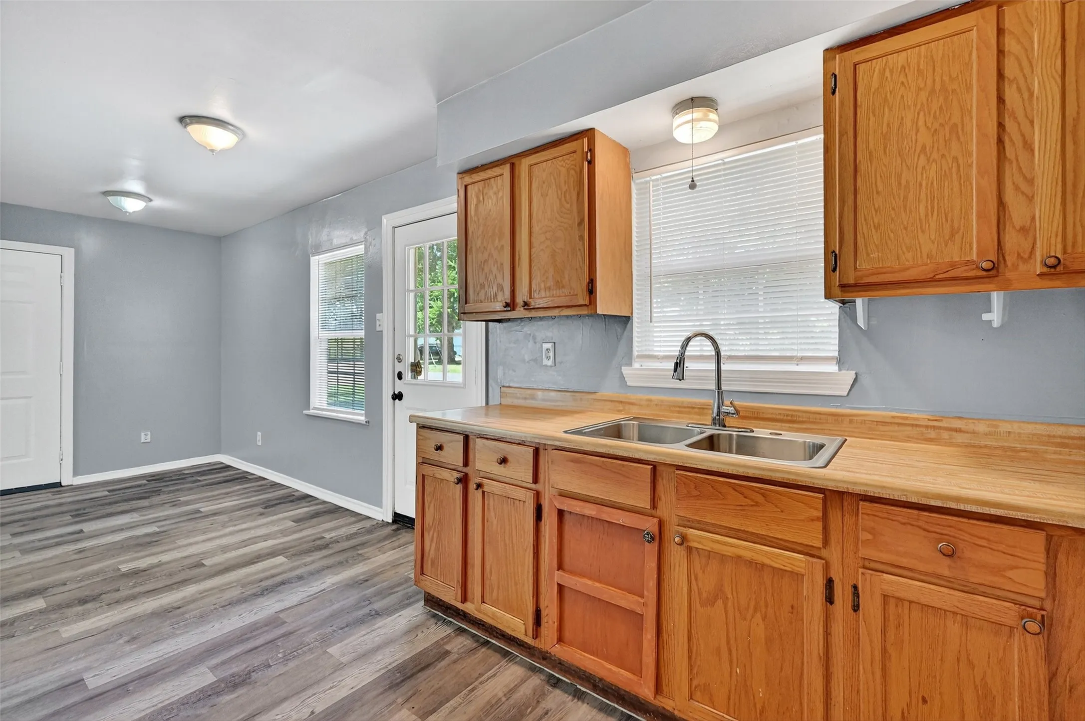 Kitchen featuring light countertops, wood finished floors, and brown cabinetry