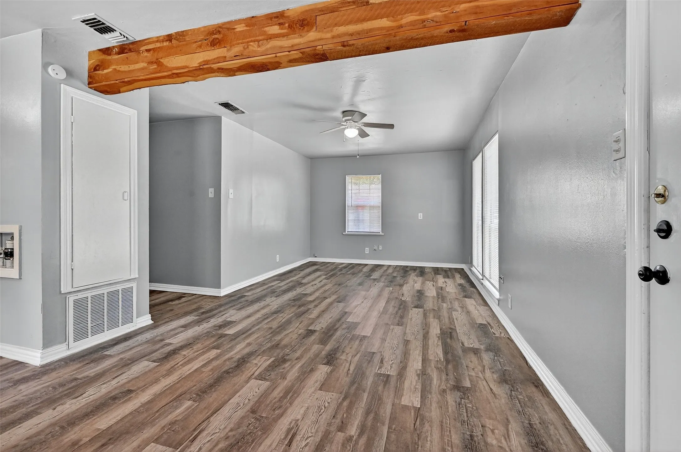Unfurnished room with wood finished floors and ceiling fan