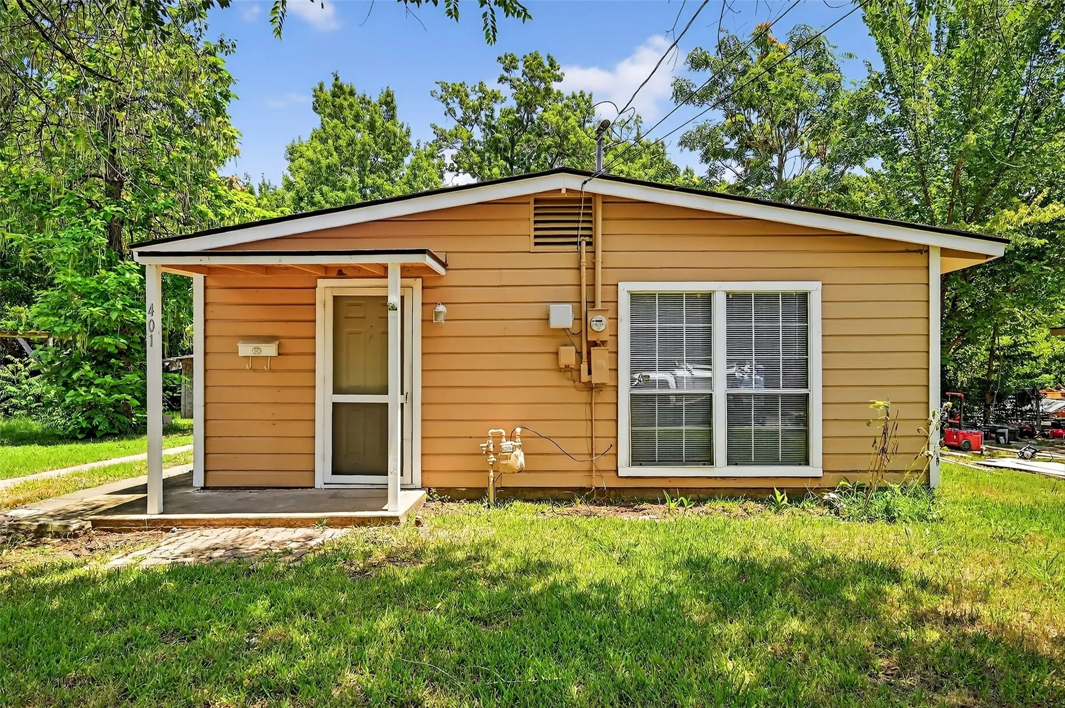 Rear view of property with a yard