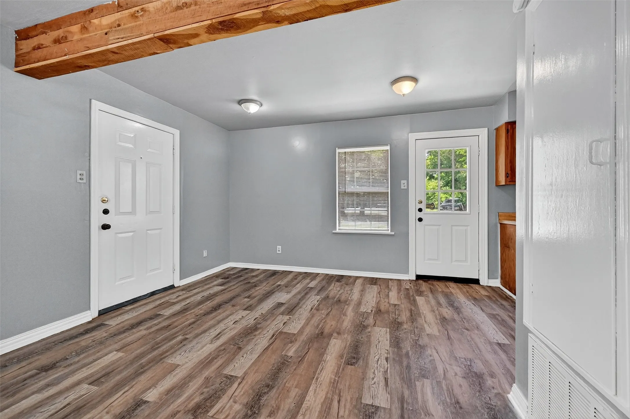 Entryway featuring dark wood finished floors and baseboards
