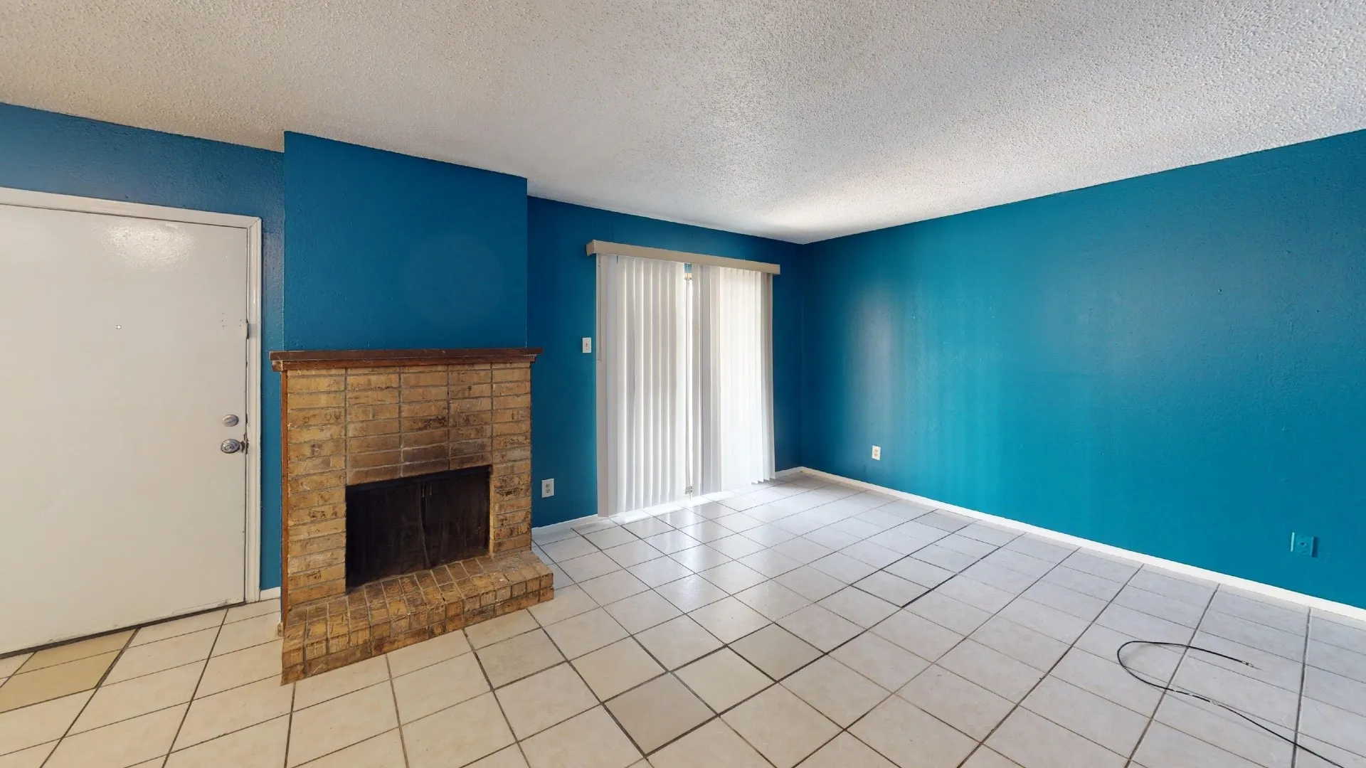 Brick fireplace feature with a wood mantel