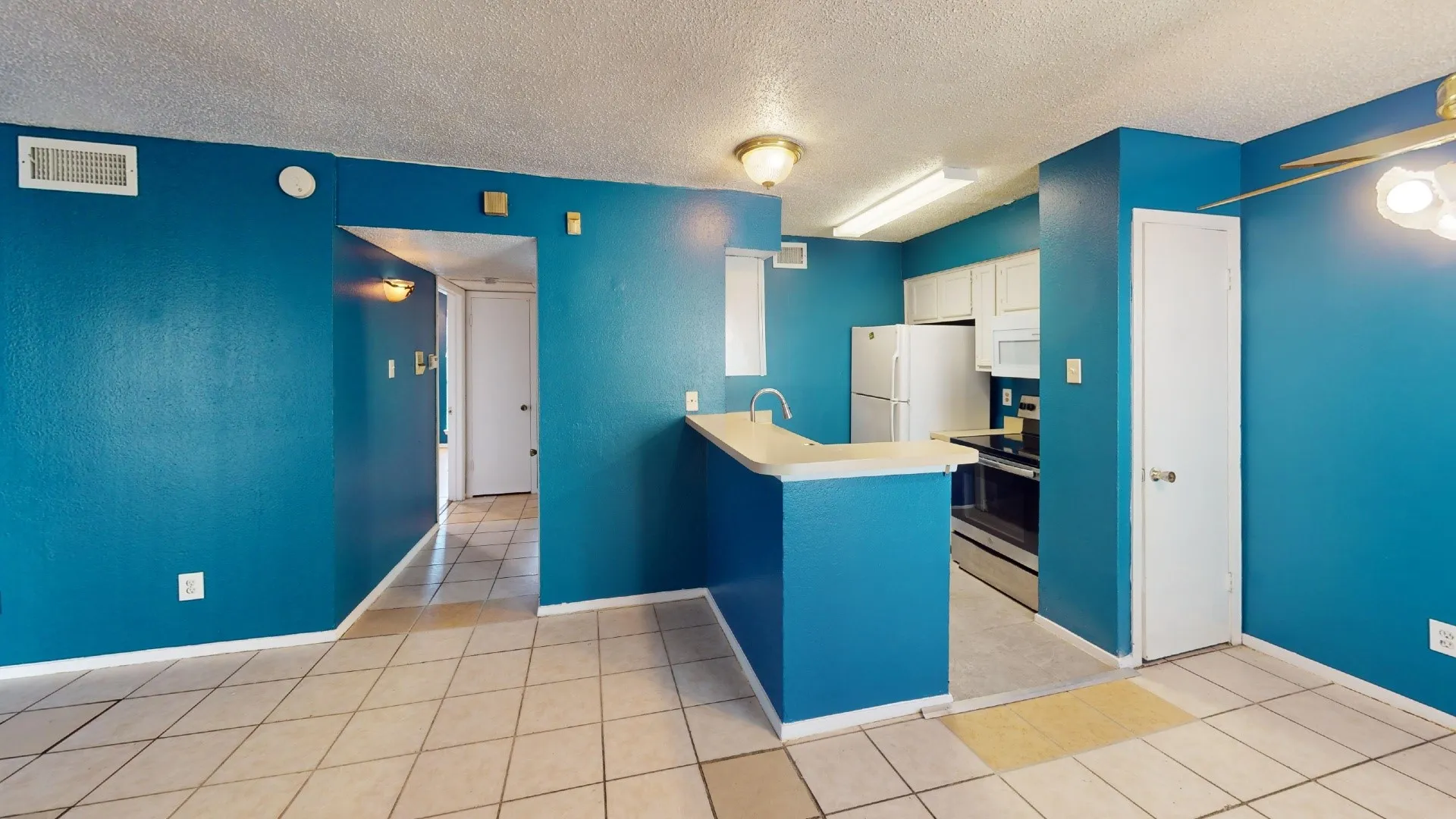 Kitchen featuring white cabinetry, a dual-basin sink, and white appliances including a refrigerator and oven