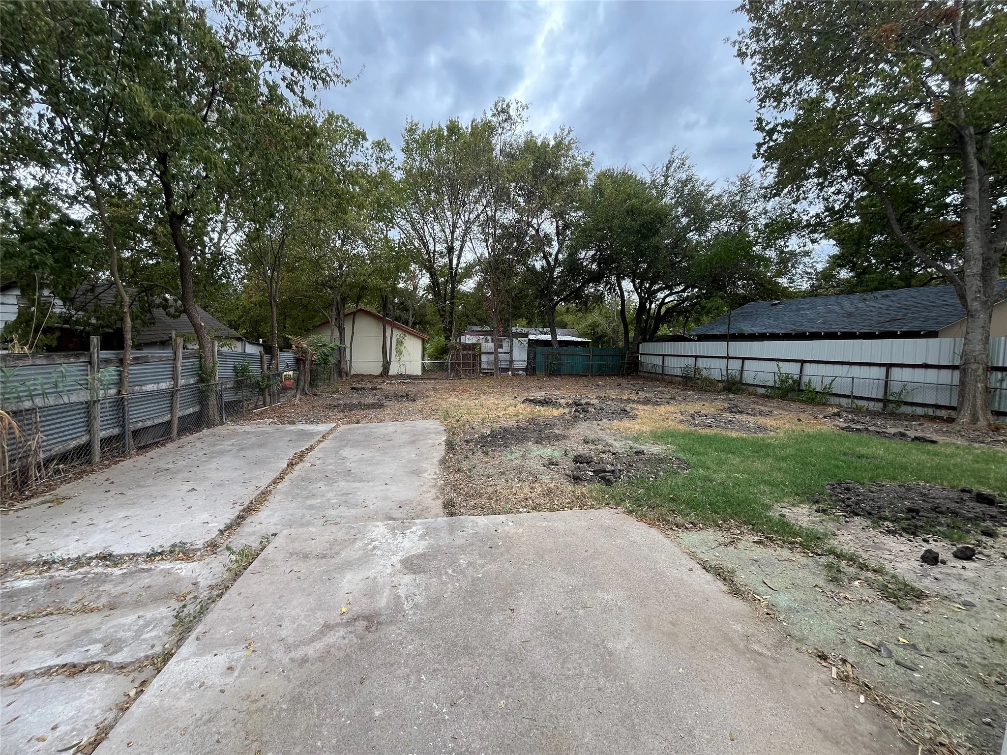 Expansive outdoor space featuring concrete patio areas and partial grass coverage