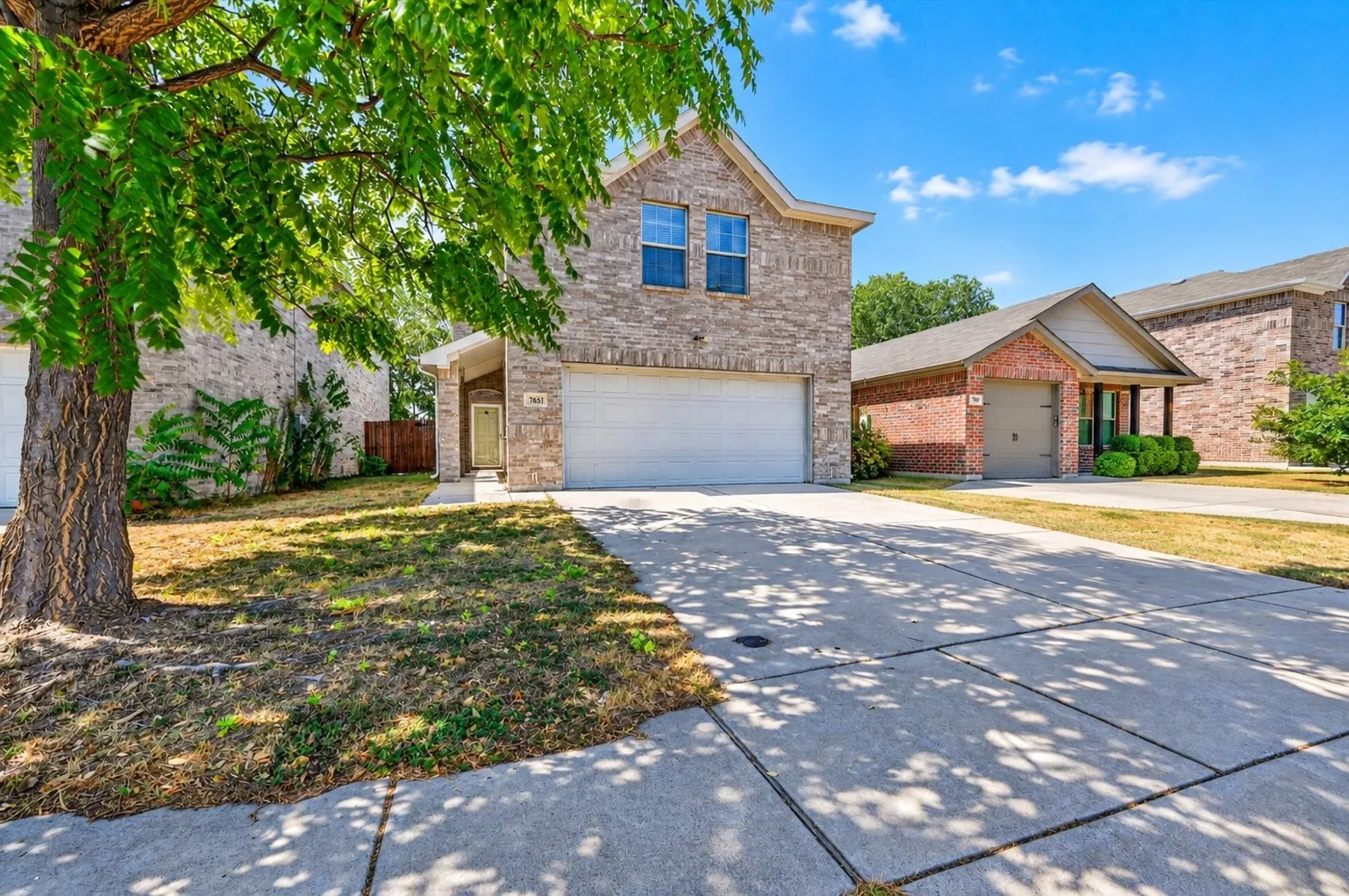 Modern 2-story brick single-family home with attached 2-car garage located in Fort Worth, Texas neighborhood