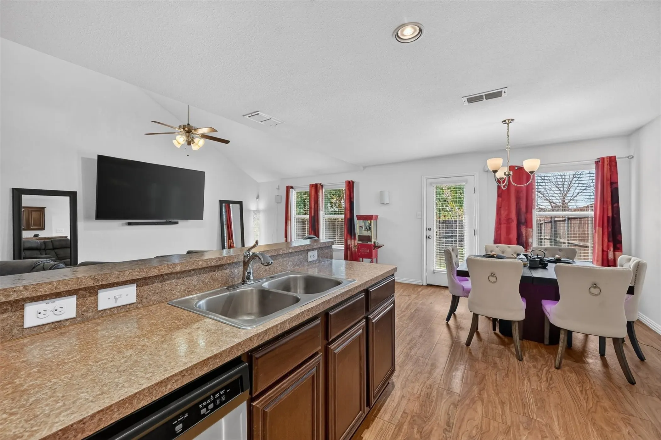 Open kitchen with breakfast bar island, recessed ceiling lighting, and dark wood cabinetry