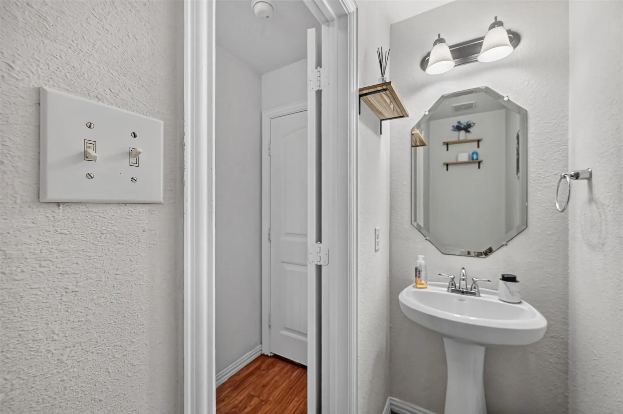 Guest bathroom featuring white pedestal sink