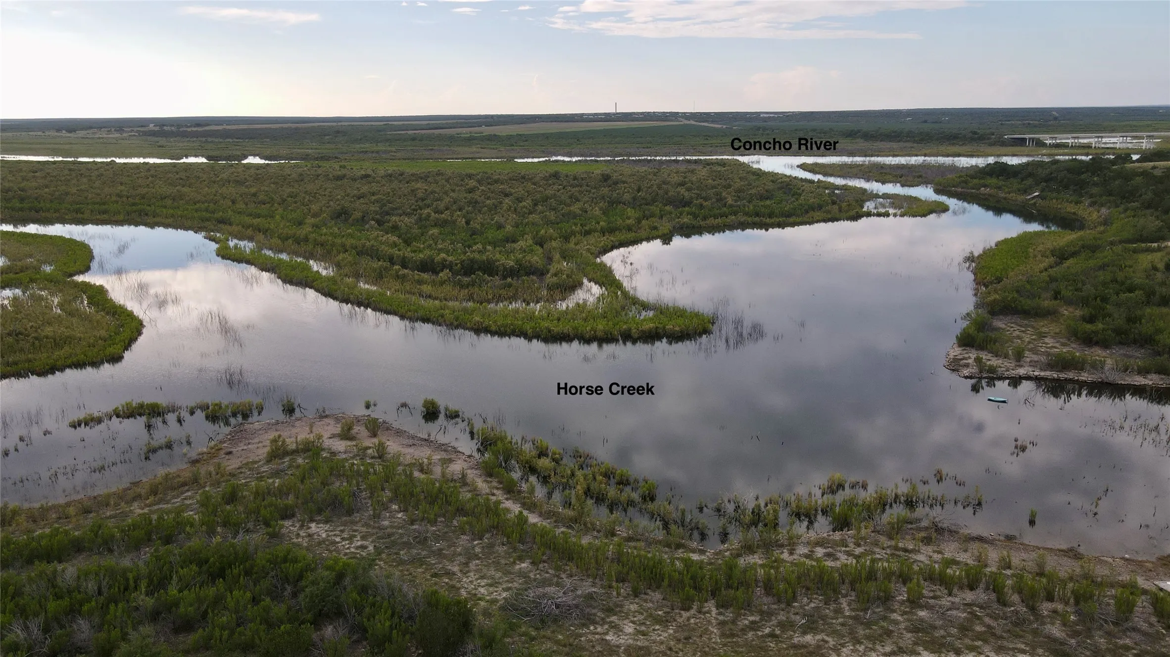 Aerial view of a large body of water and a heavily wooded area