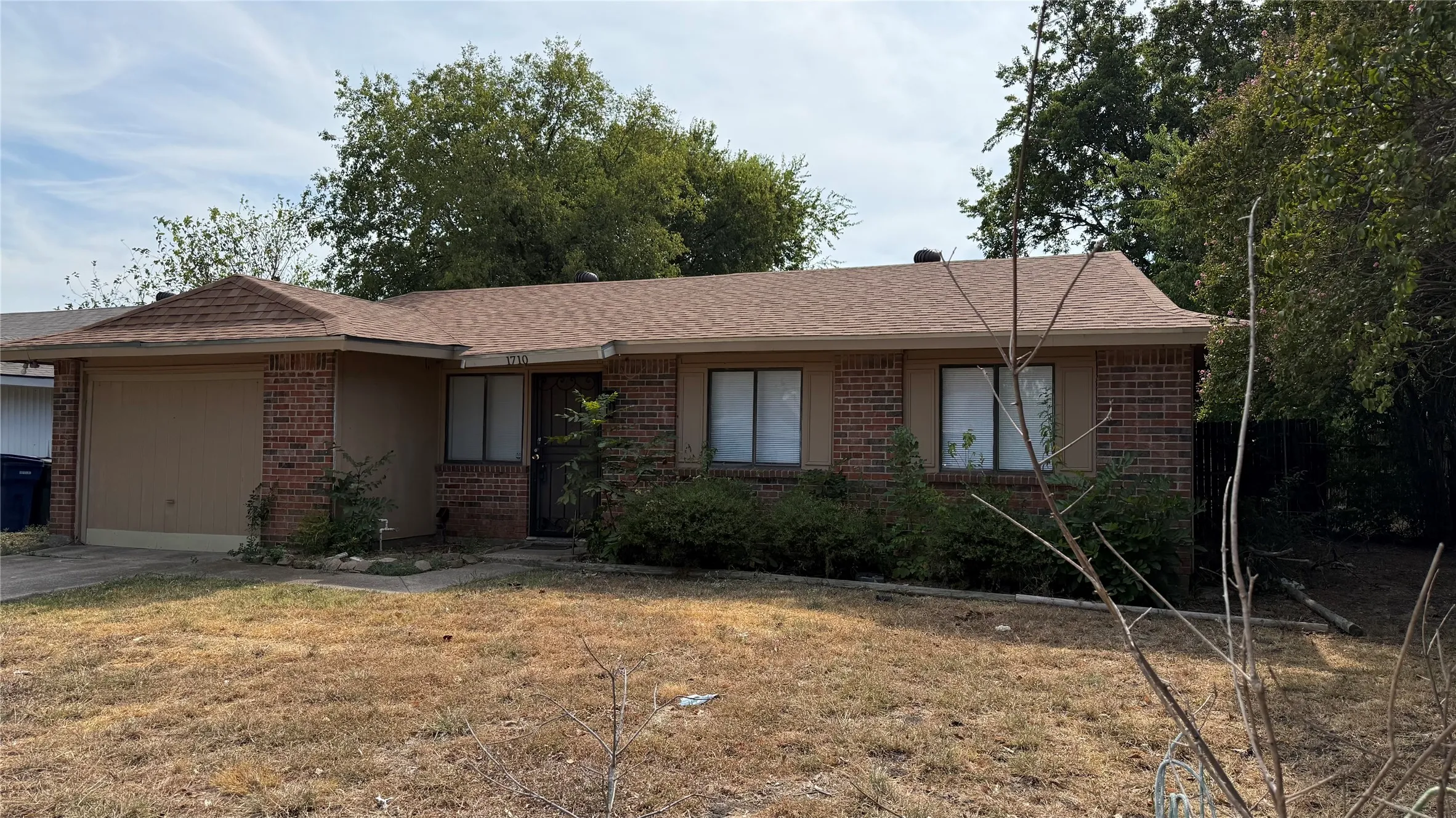 Brick exterior with a single-car garage and a pitched roof