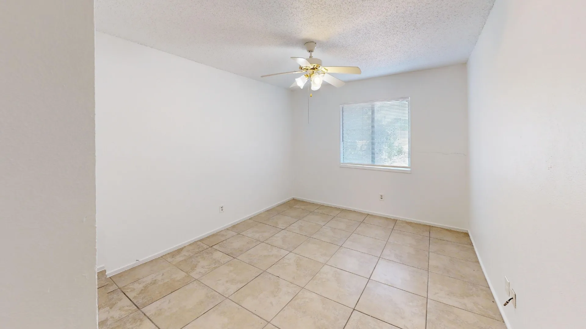 Tiled flooring, overhead ceiling fan, and a window with natural light