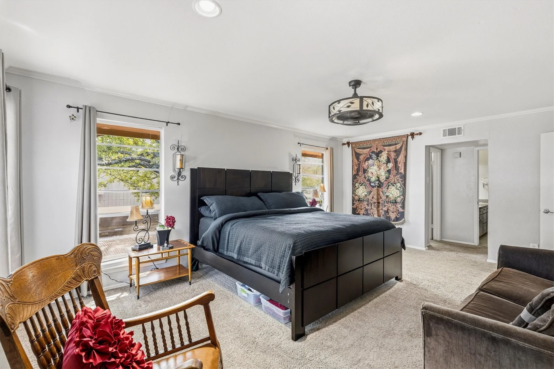 Carpeted room featuring recessed lighting, a ceiling fan, and multiple windows