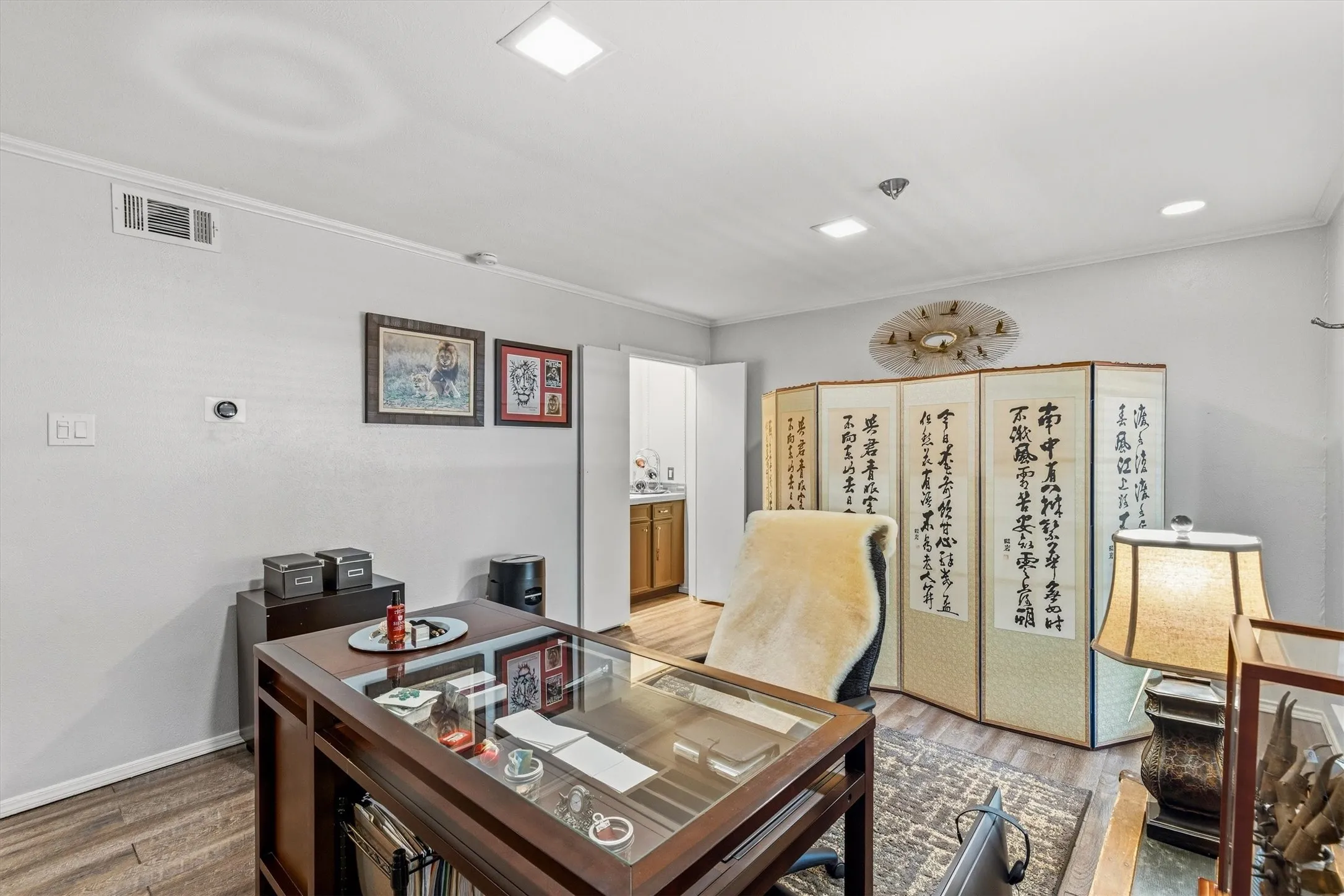 Recessed ceiling lighting, wood-finish flooring, and white painted walls