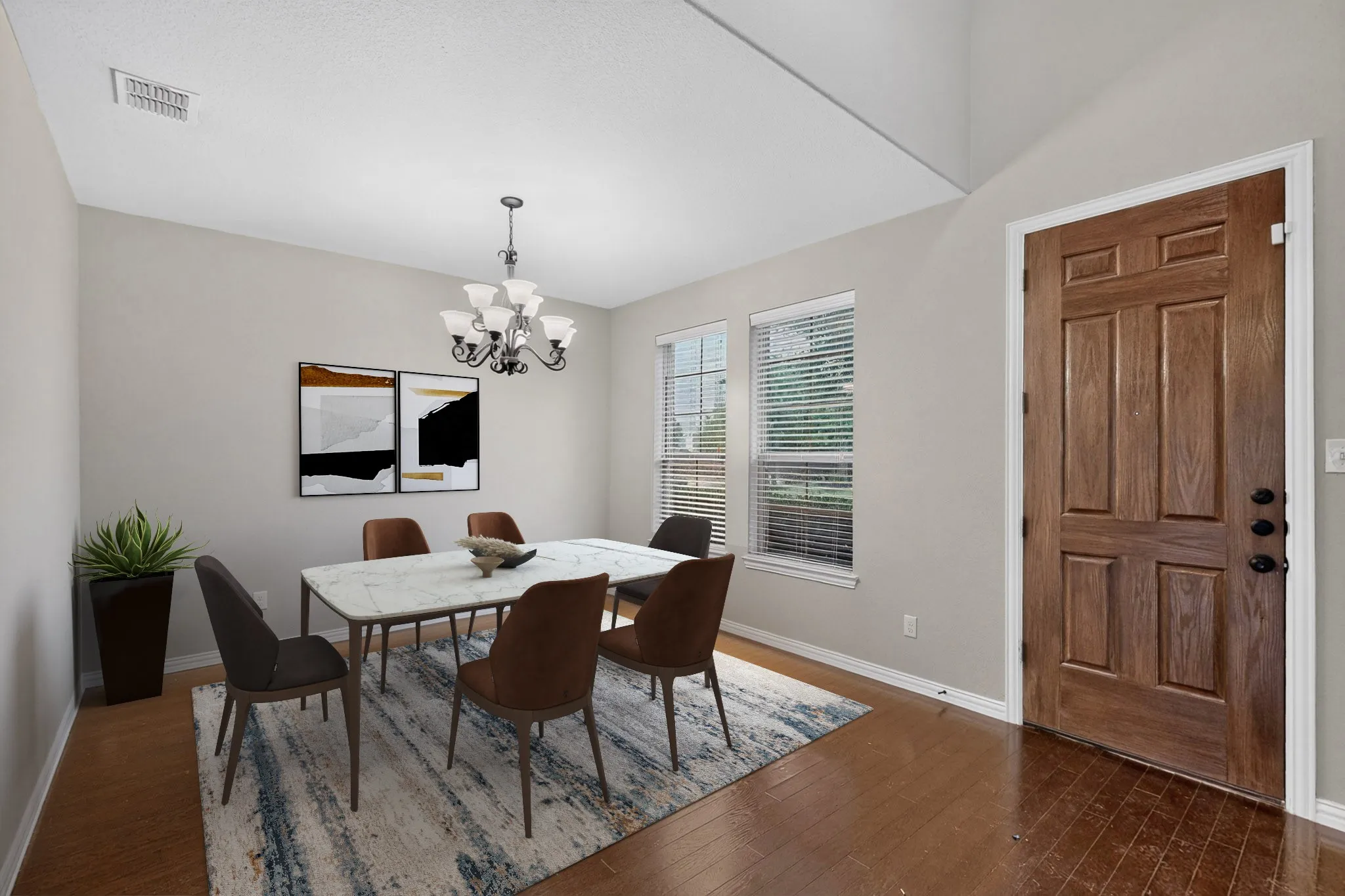 Wood-finish flooring throughout, vaulted ceiling, two windows with blinds, recessed lighting, and a paneled wood door