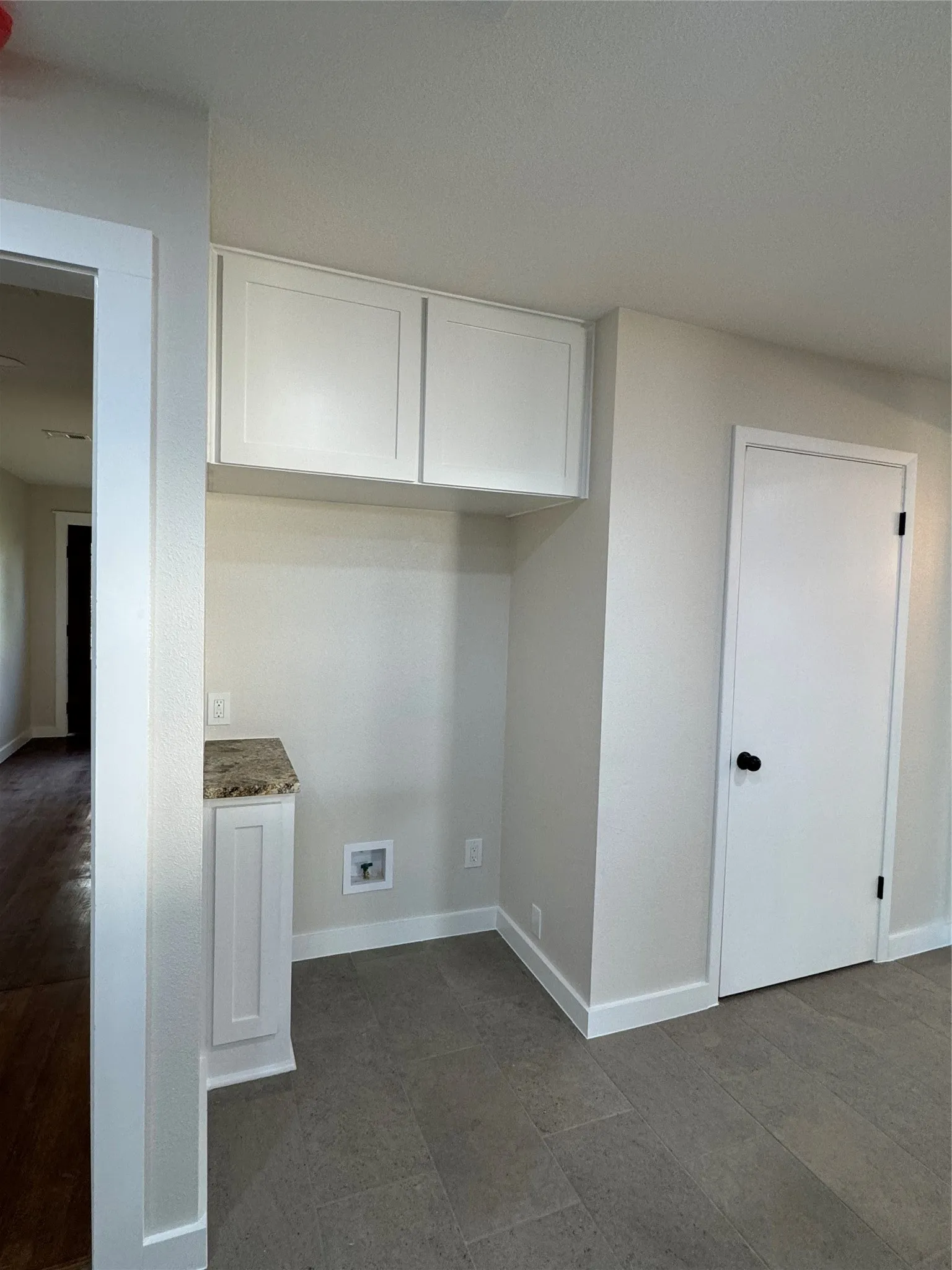 Washroom with cabinets and washer hookup