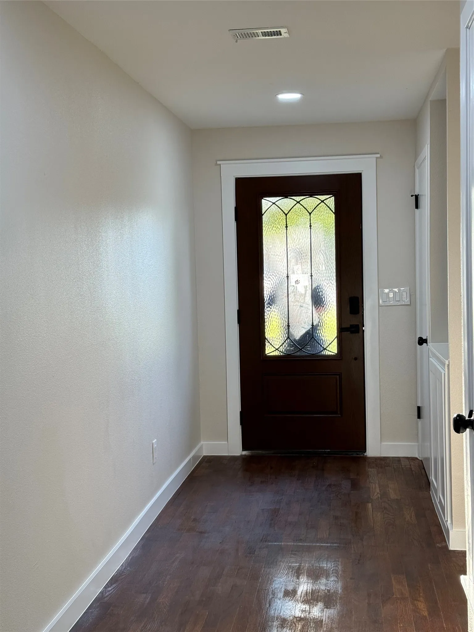 Entrance foyer featuring dark hardwood / wood-style floors