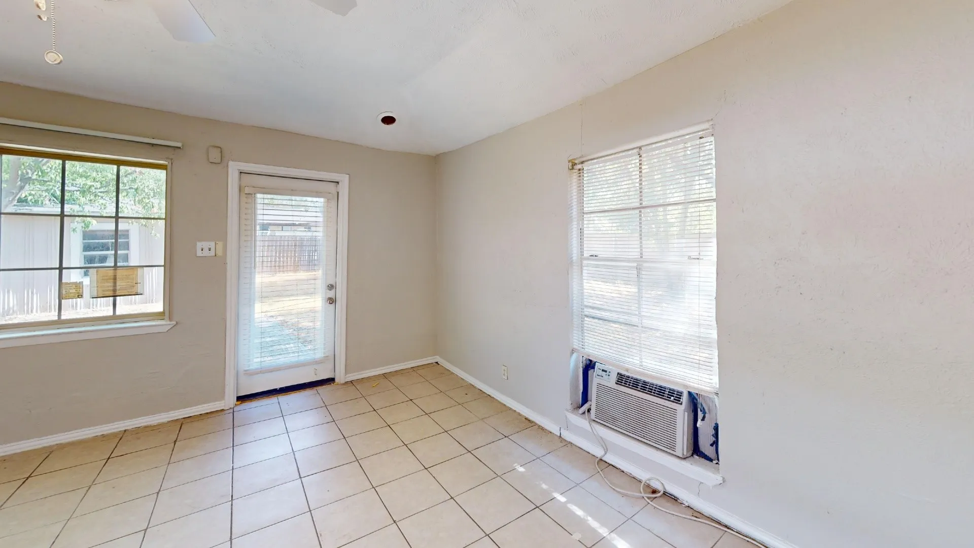 Tile flooring, ceiling fan, recessed lighting, and a glass-paneled door