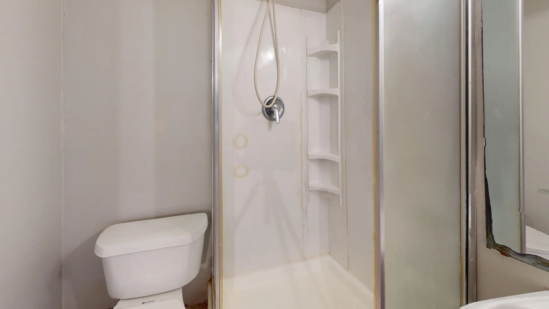 Fiberglass shower enclosure with integrated shelving and chrome fixtures