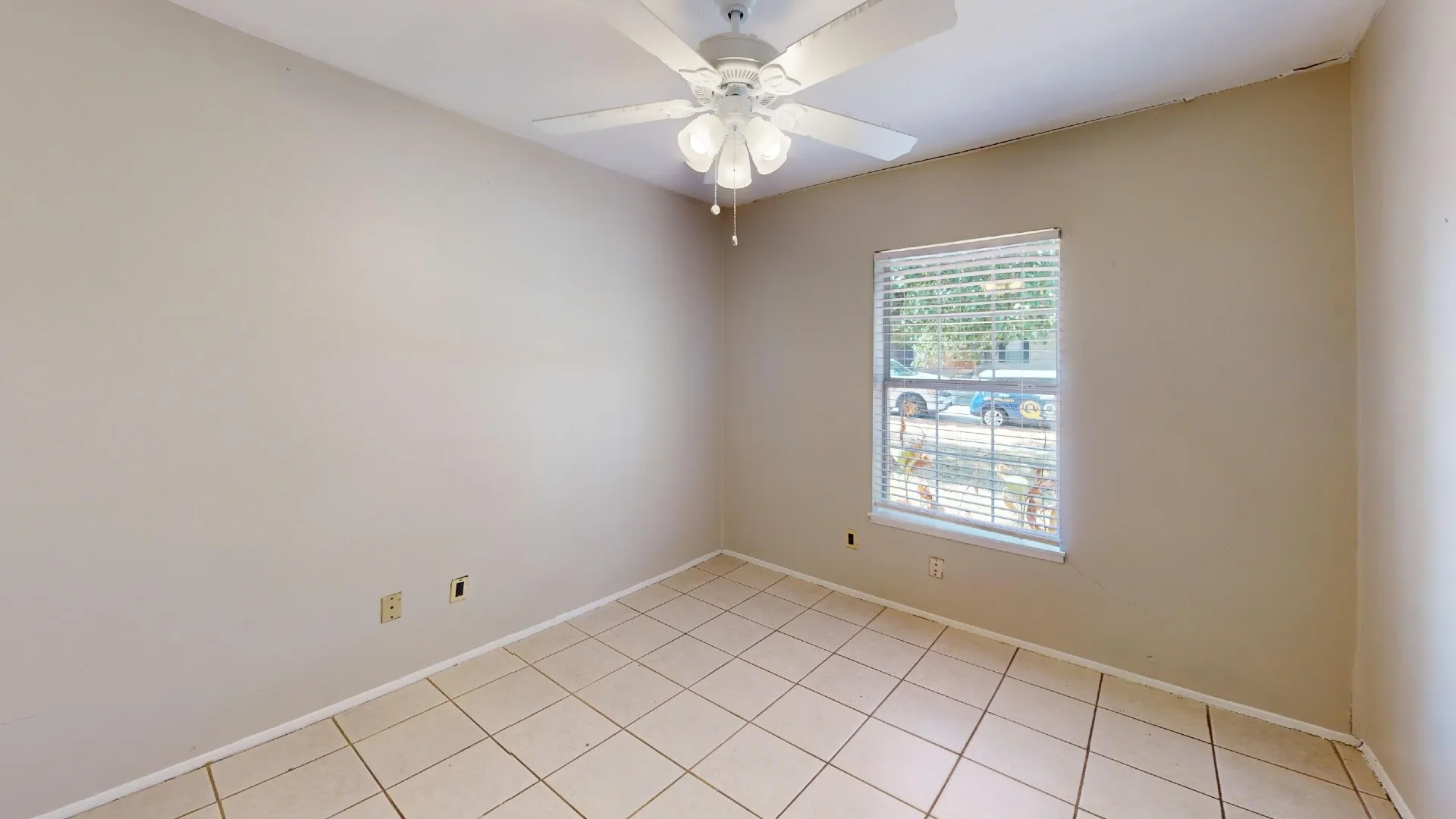 Tile flooring with a neutral finish, white window blinds, and a ceiling fan with integrated lighting