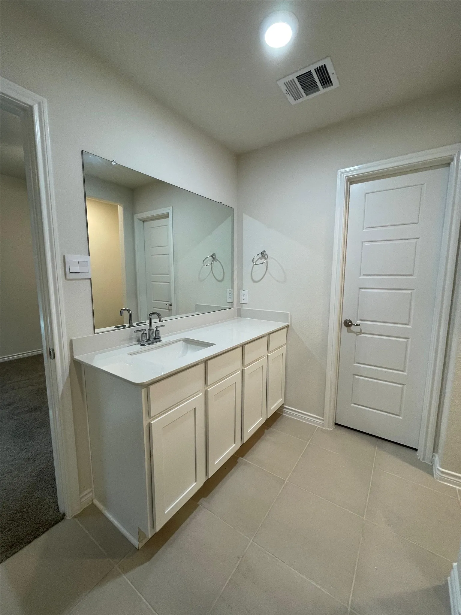 Bathroom featuring vanity and tile patterned flooring