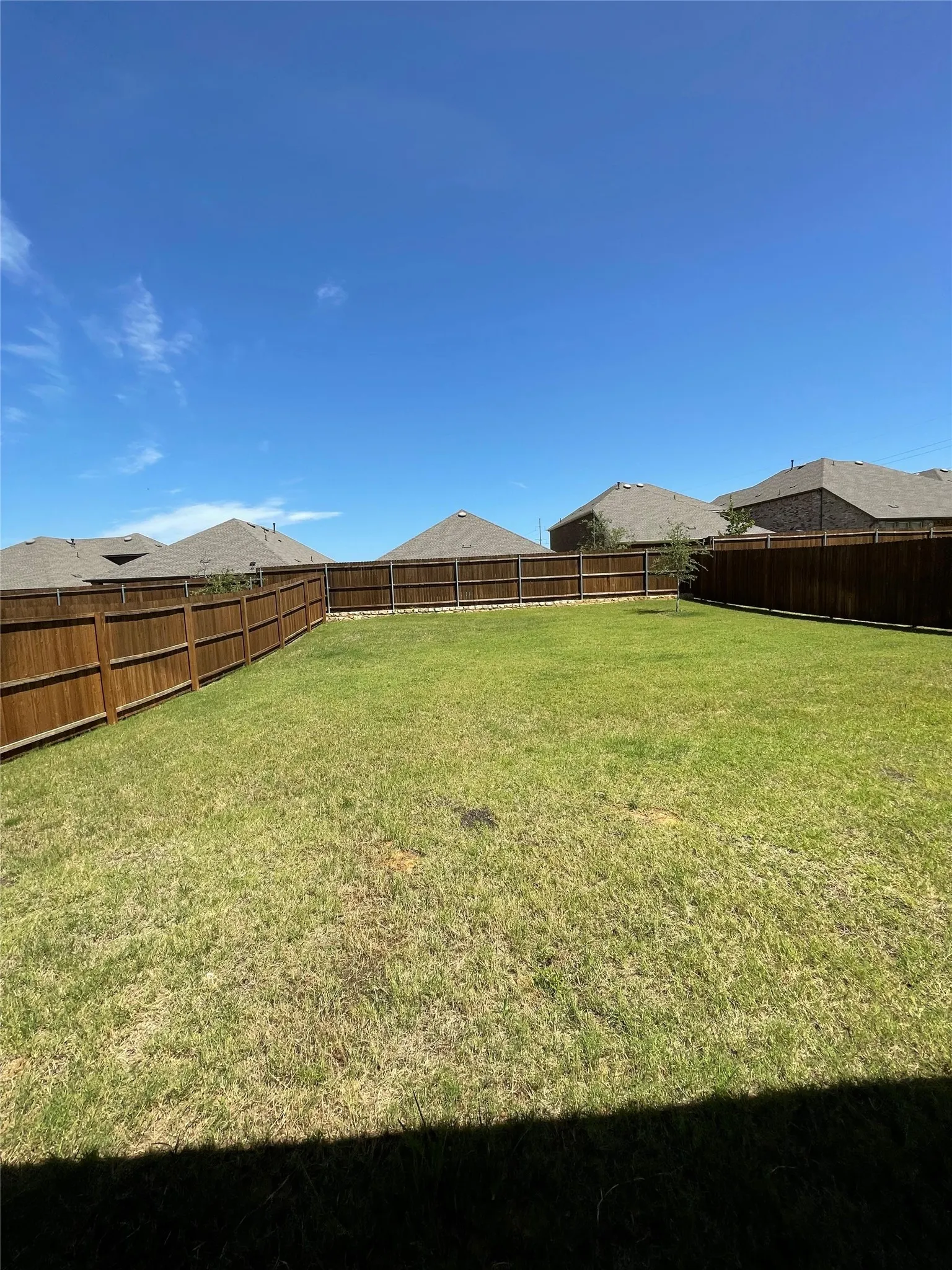 Fenced backyard with a residential view