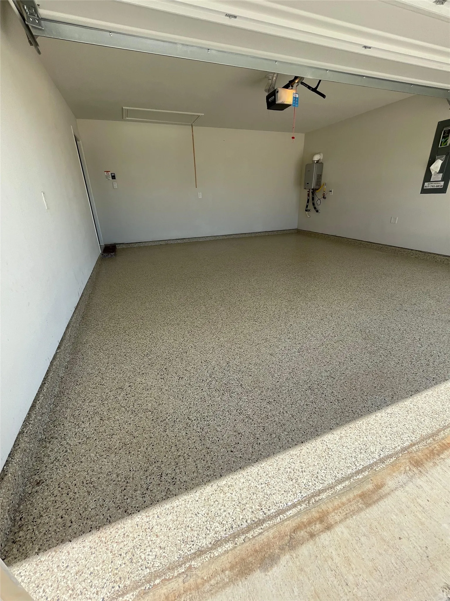 Garage featuring a garage door opener