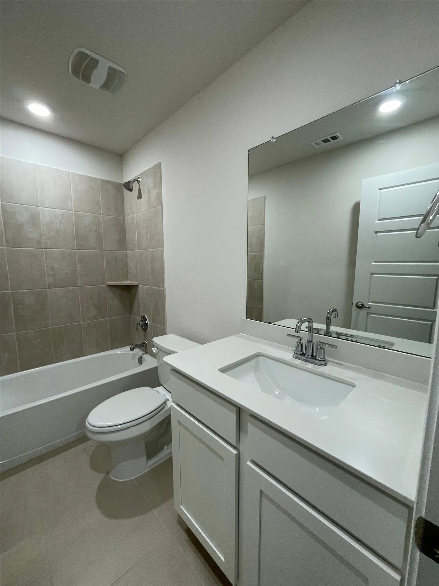 Full bath featuring vanity, bathtub / shower combination, recessed lighting, and tile patterned floors