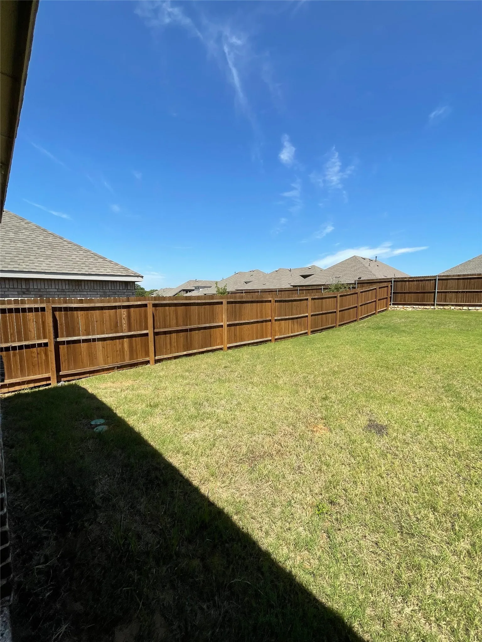 View of fenced backyard