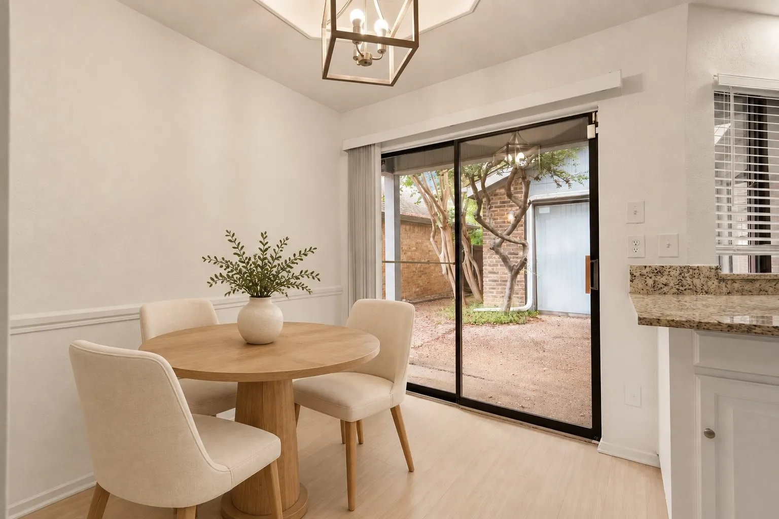 Breakfast nook with a sliding door to the courtyard. Virtually staged.
