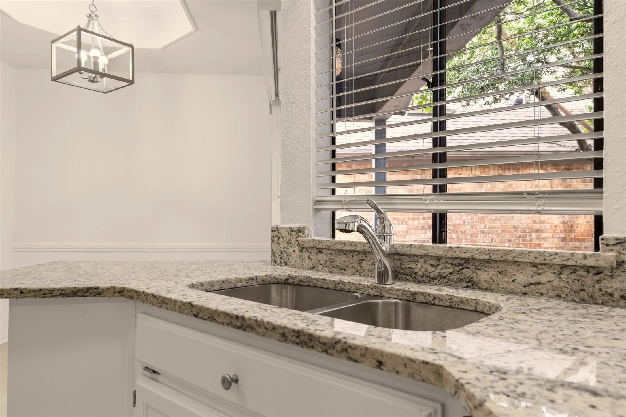 Undermount sink under a window.