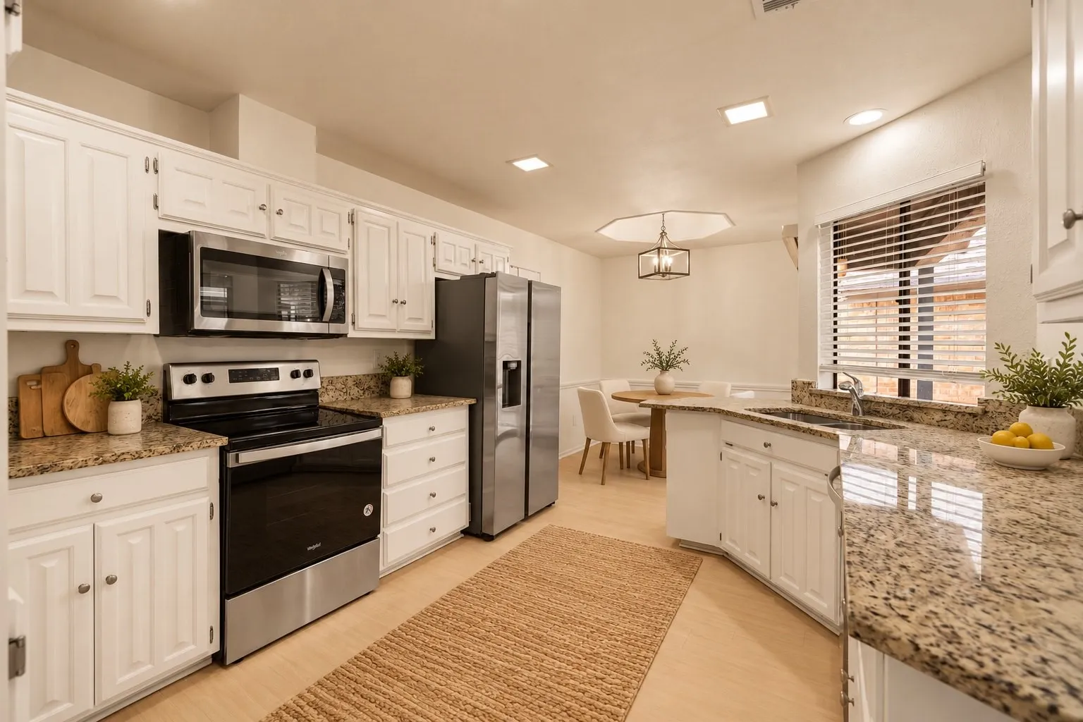 Kitchen open to the breakfast nook. Virtually staged.