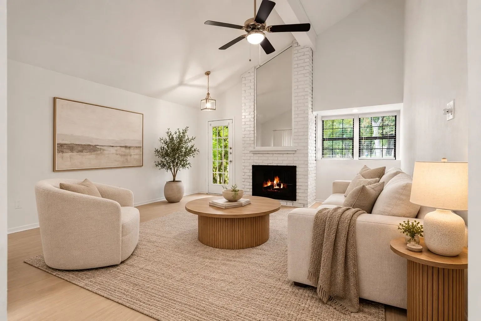 Living room with brick fireplace and vaulted ceiling. Virtually staged.
