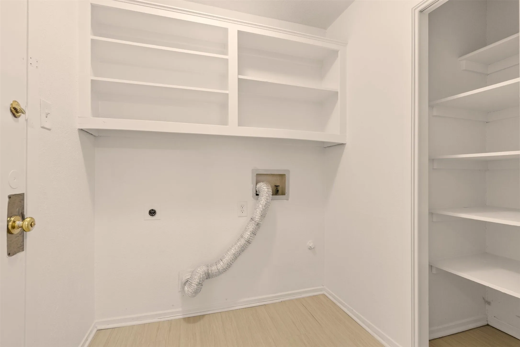 Laundry room with built-in shelves.
