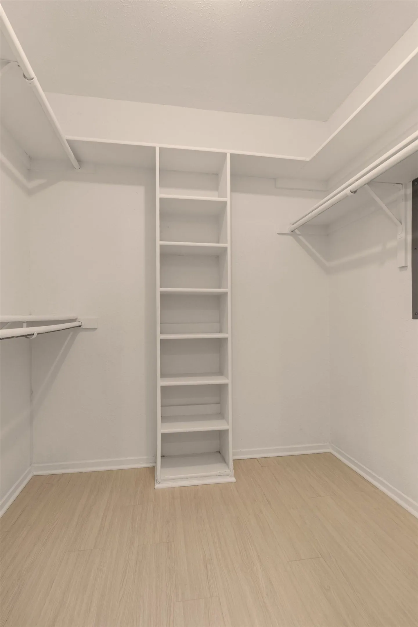 Walk-in closet with built-in shelves off the second bath.
