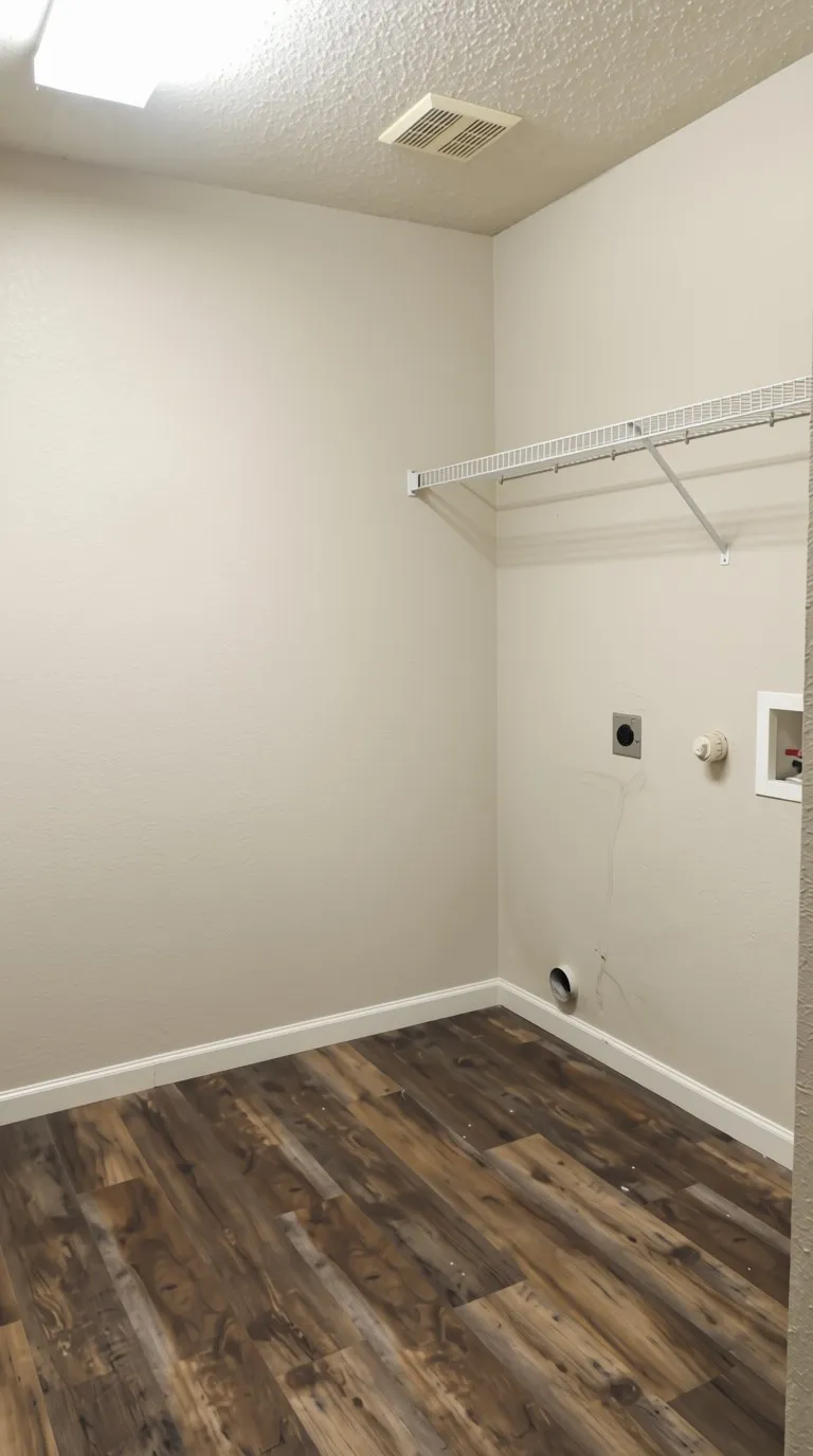 Laundry room featuring wood-finish flooring, light-toned walls, overhead lighting, and a wire shelving unit