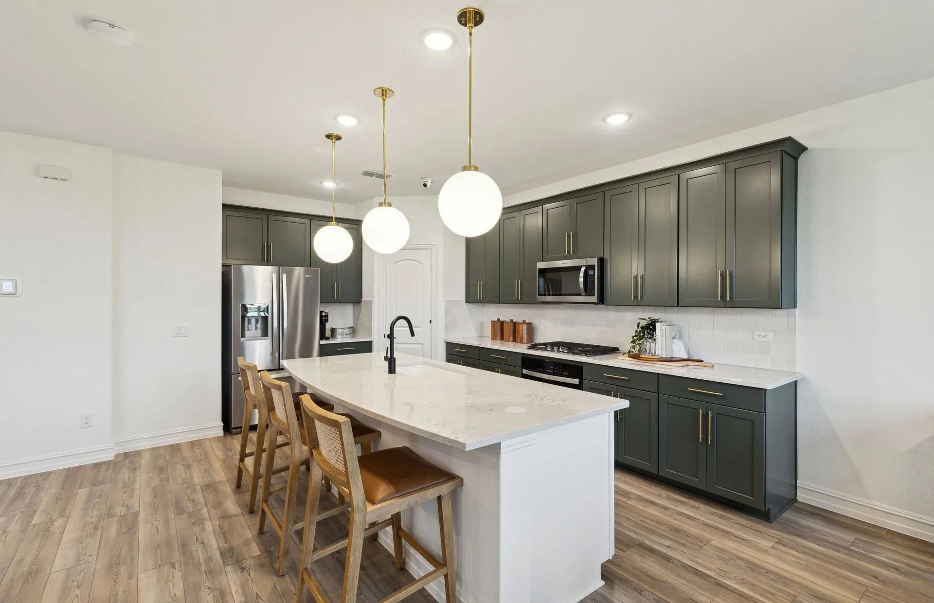 *Model Representation - Large island overlooking gathering room and dining areas