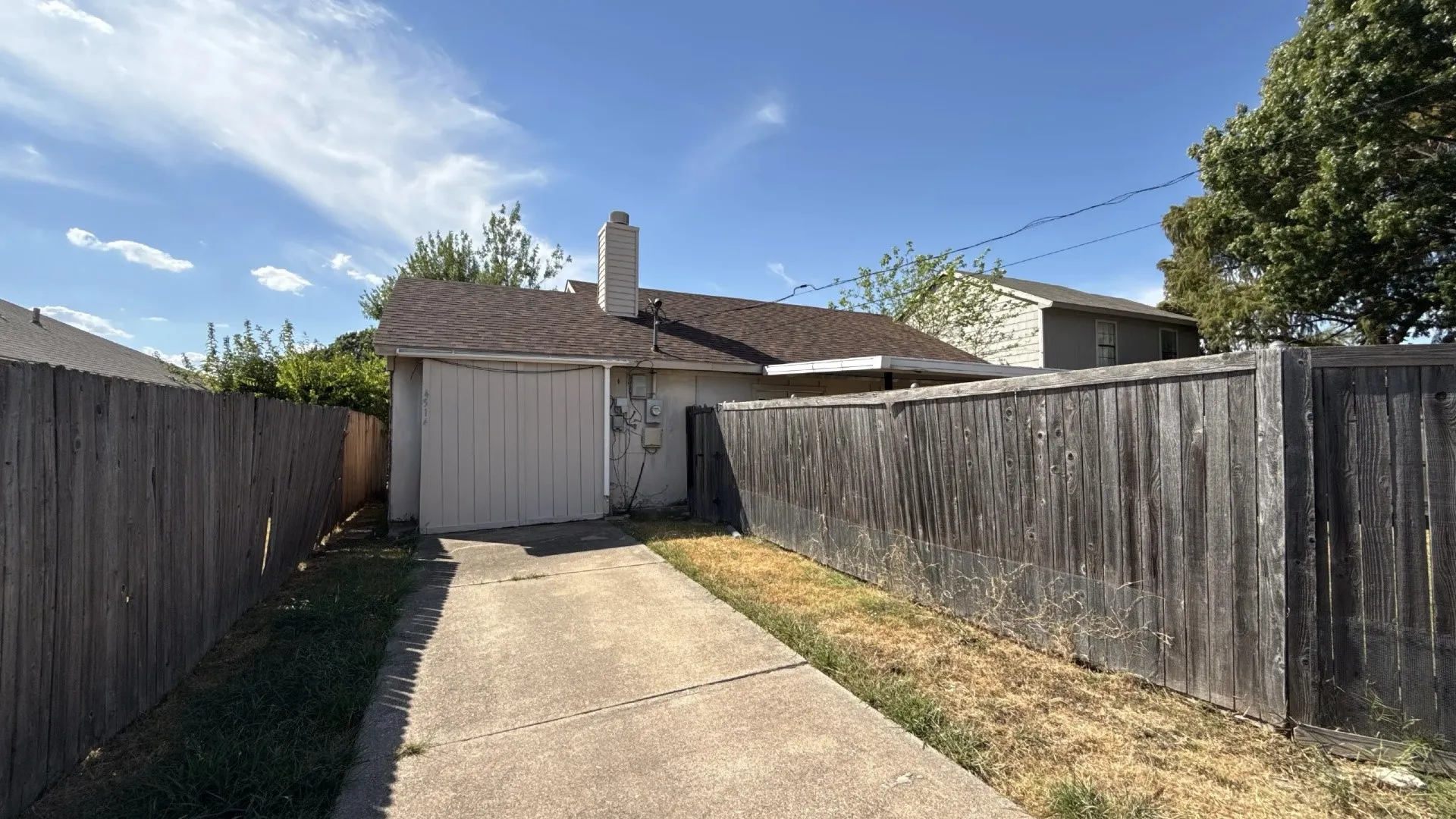 Paved driveway leading to a rear-facing attached garage
