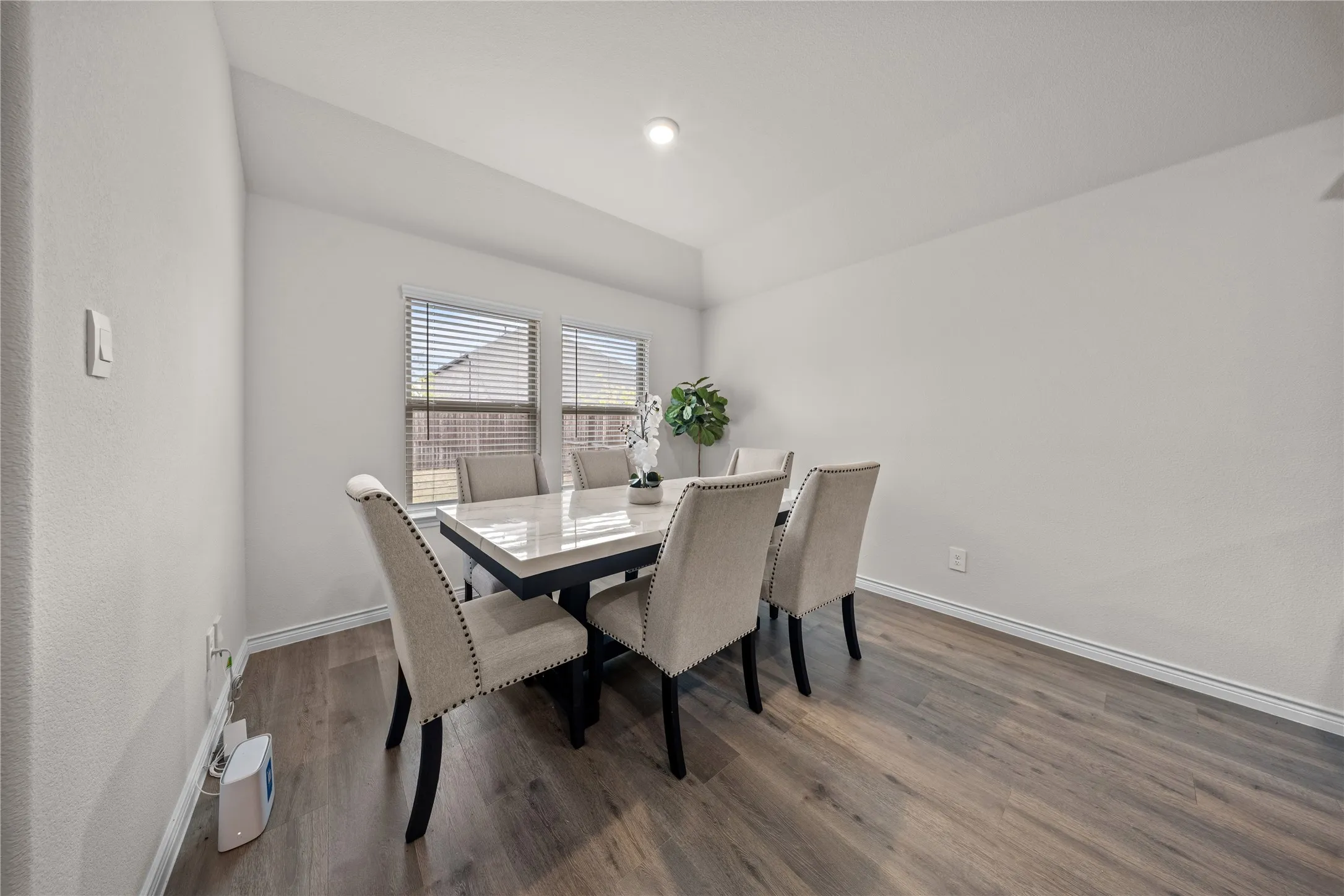 Wood-finish flooring with white walls and trim