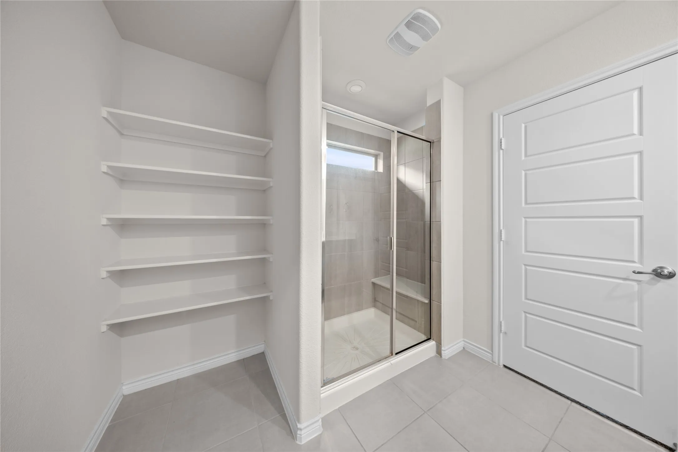 Spacious shower with a glass enclosure and built-in bench