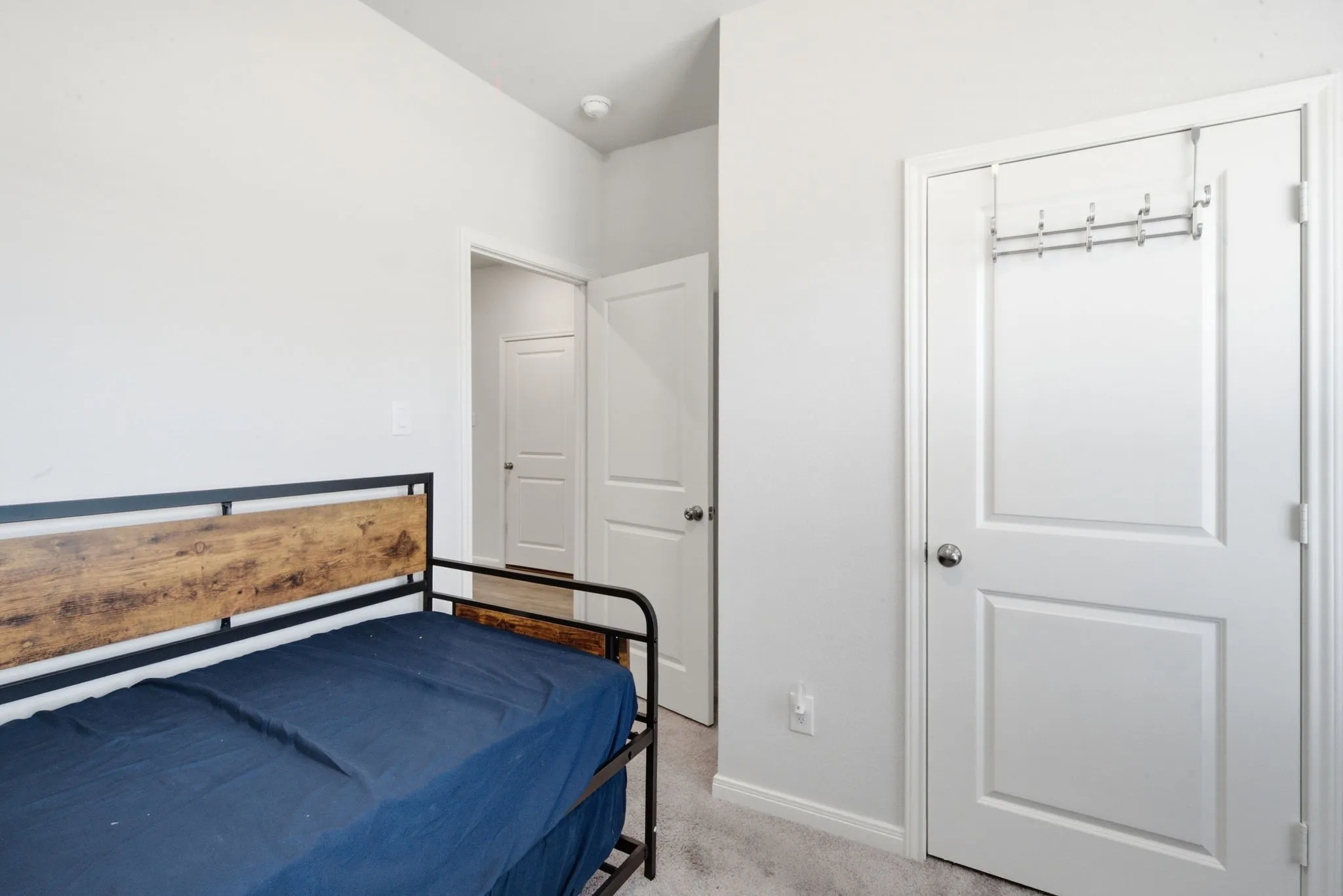 Carpeted flooring, white walls, and white trim