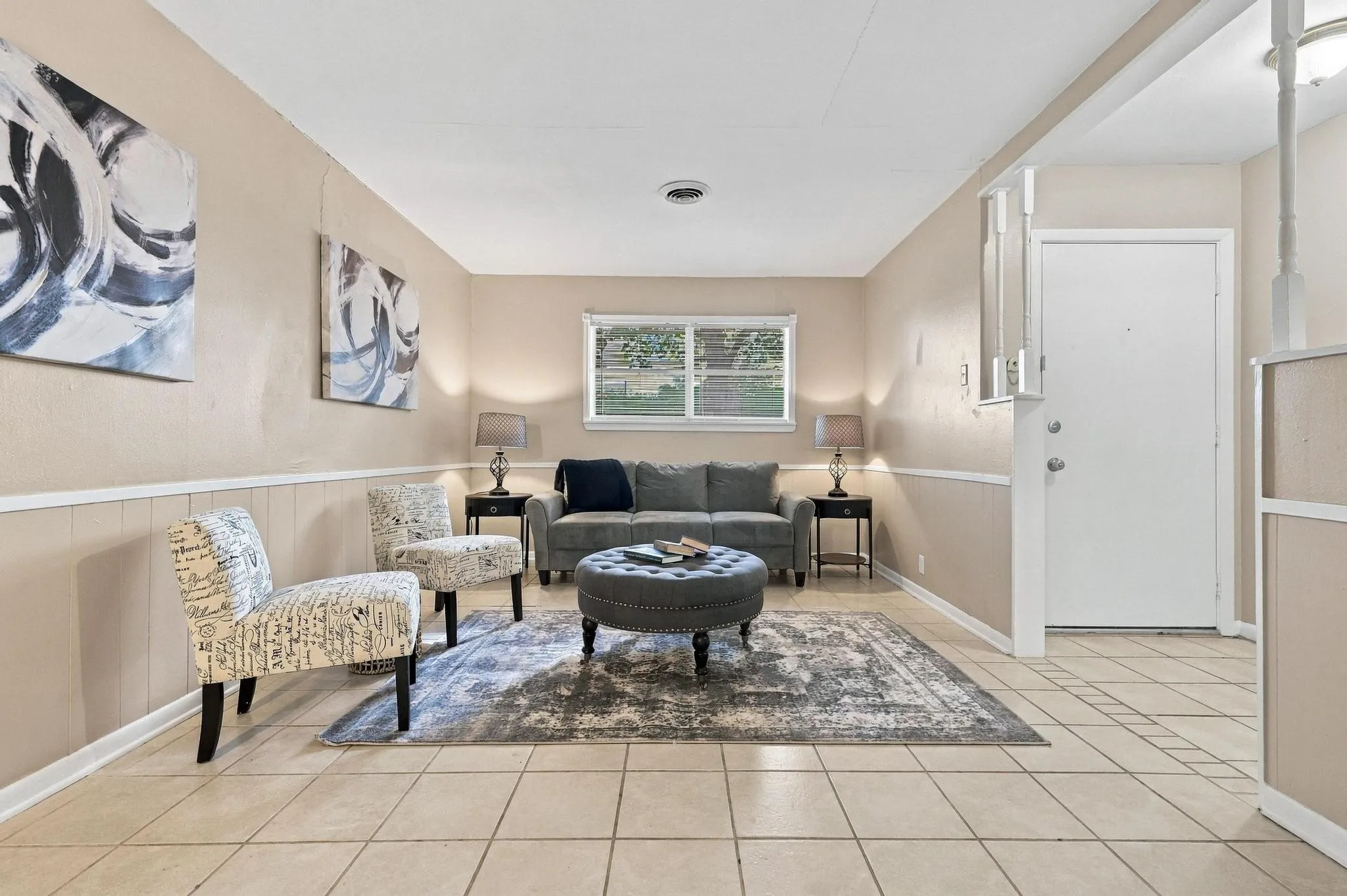 Neutral tone wall paint with white wainscoting and trim, offering a cohesive design
