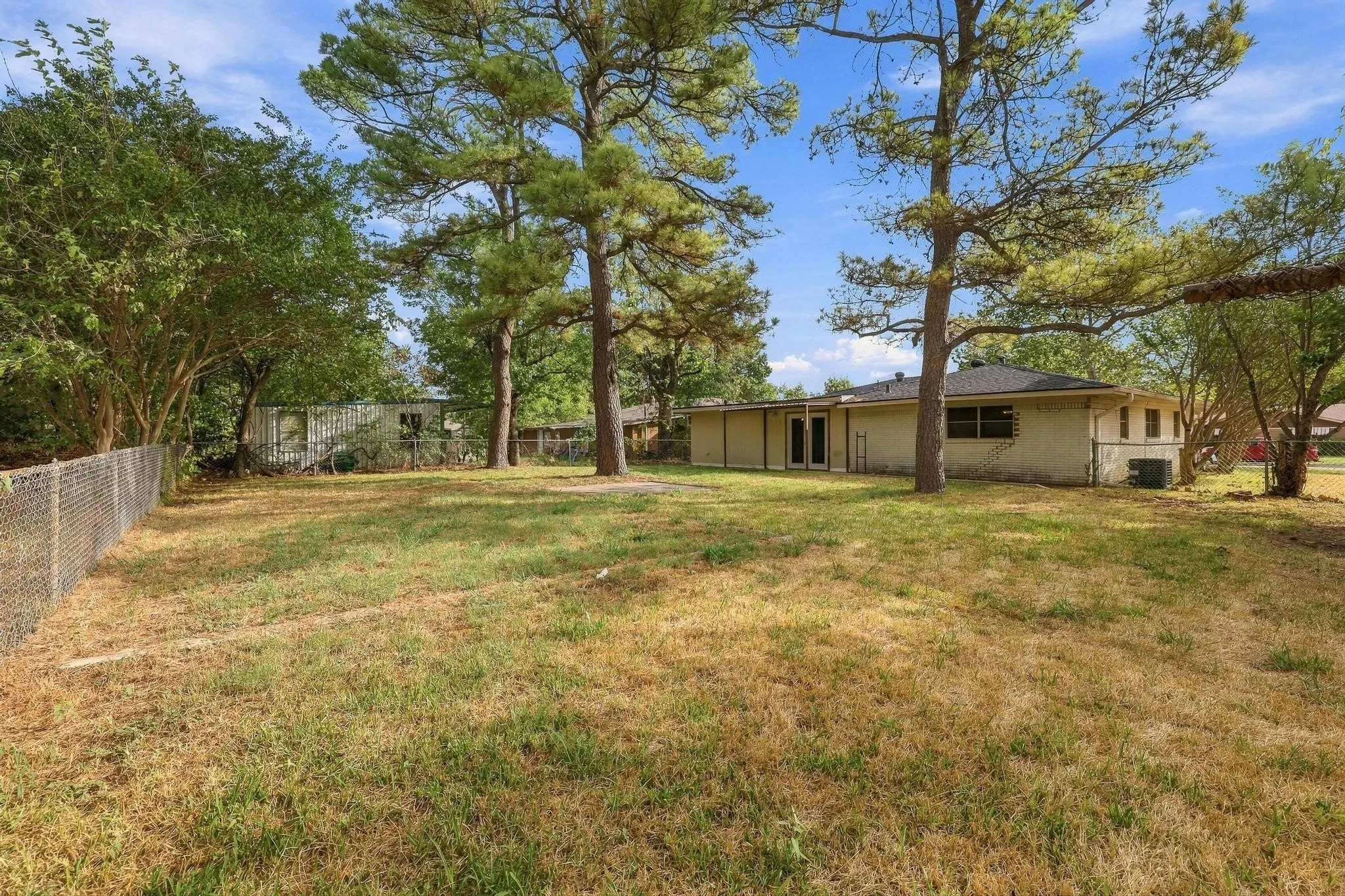 Large fenced backyard with plenty trees